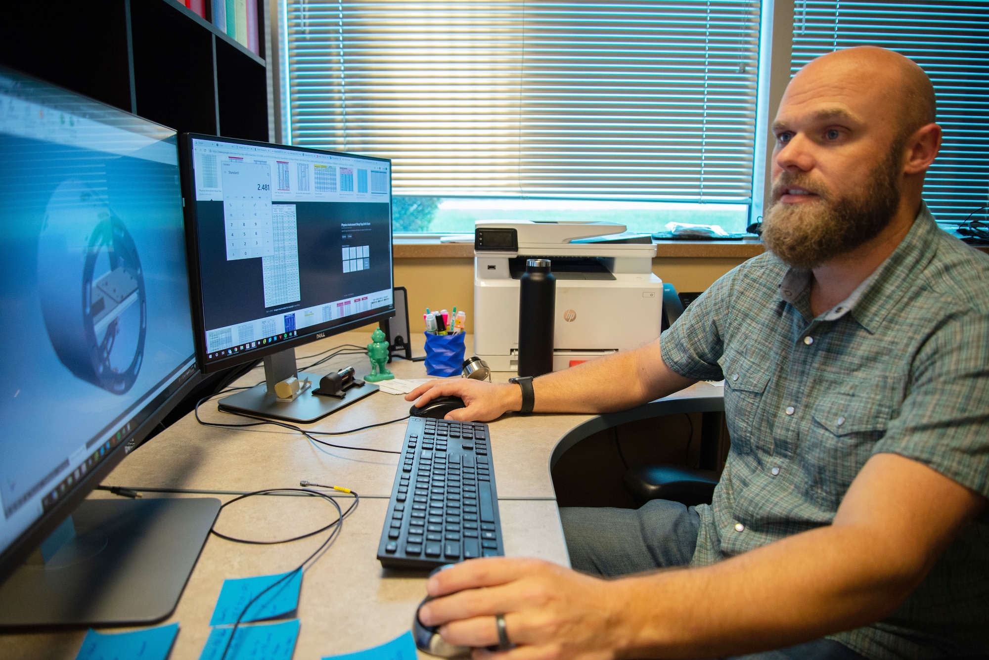 Maker Hub Manager Tom Mitchell works on a designing a part using computer aided design and drafting software in support of an Air Force Research Laboratory project.