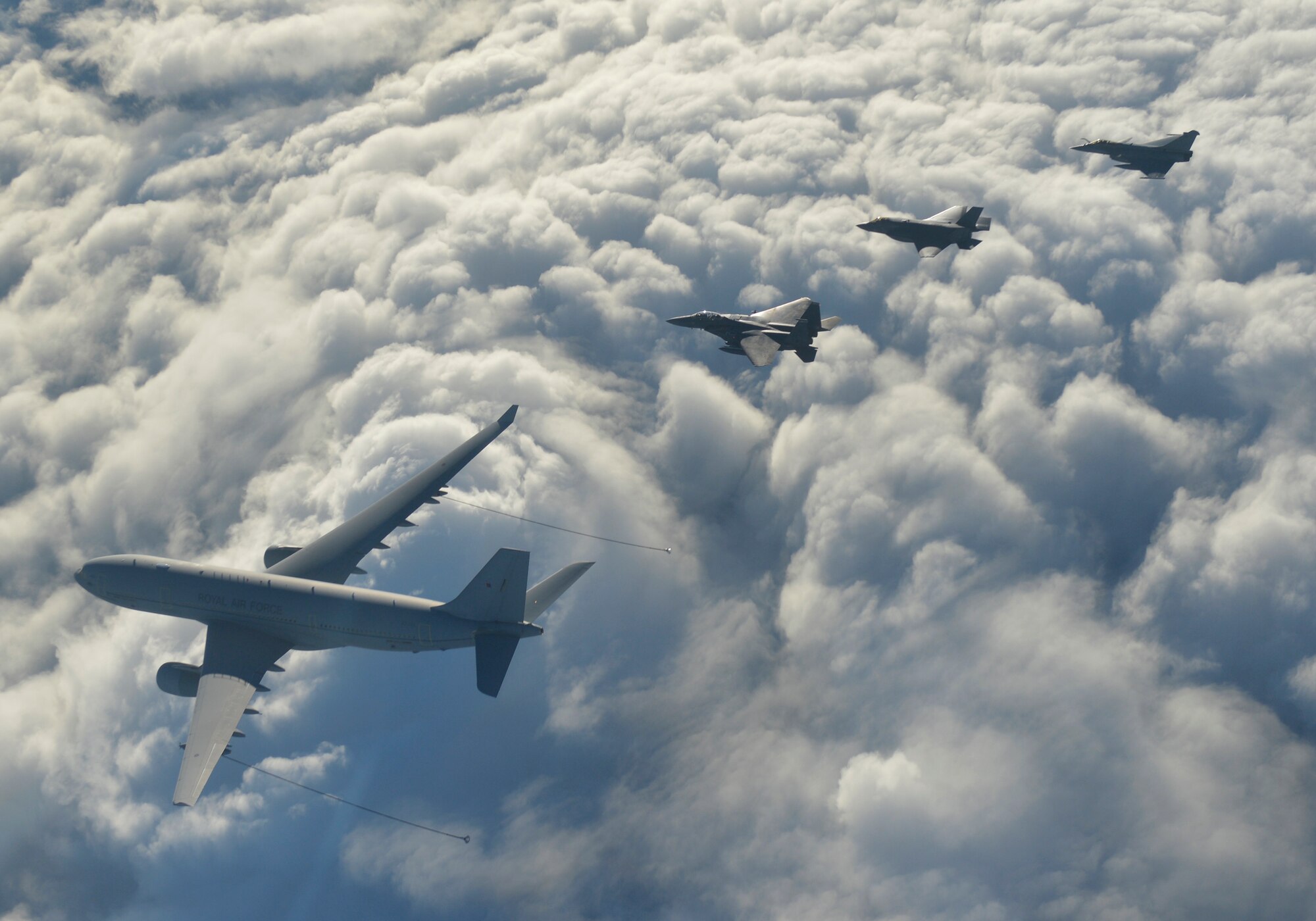 A U.S. Air Force F-15E Strike Eagle from RAF Lakenheath, a Royal Air Force Voyager from RAF Brize Norton, a RAF F-35B Lightning II from RAF Marham and a French Air Force Rafale
