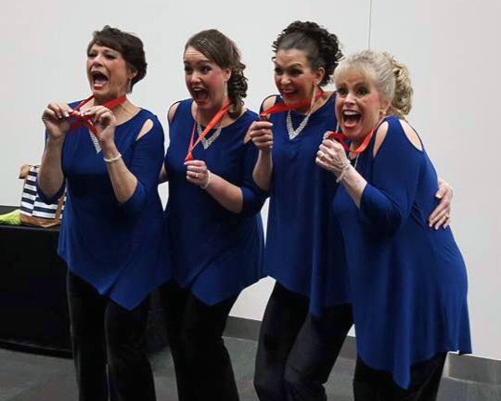 Brilliance Quartet show their awards April 30, 2018. The group sings a cappella, four-part harmony music.