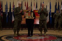 Deborah Hager, Pfc. George W. Elmore’s niece, is presented a token of appreciation during a ceremony, where Camp Allen was rededicated as Camp Elmore in honor of Korean War Navy Cross recipient, Pfc. Elmore, Nov. 27, 2018 at Camp Elmore, Norfolk, Virginia. Elmore, while serving as an automatic rifleman in Korea, was killed February 26, 1951 and was posthumously awarded the Navy Cross. In 1953, Camp Elmore was the first Marine Corps installation to be named in honor of an enlisted Marine. (U.S. Marine Corps photo by Sgt. Jessika Braden/ Released)