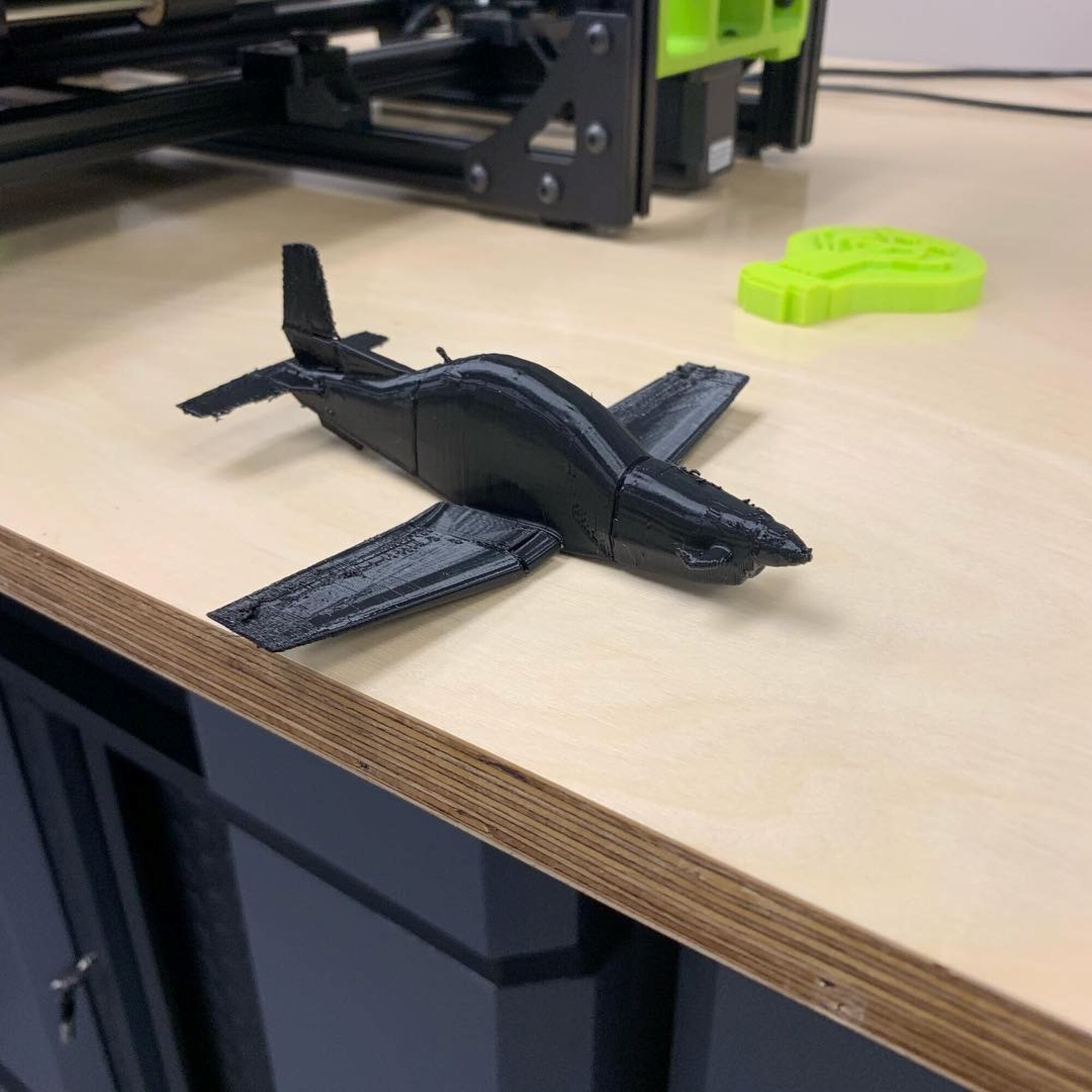 A 3D printed T-6 Texan II model sits on a desk, showing the practicality of a 3D printer in the Spark Cell on Columbus Air Force Base, Mississippi. (Curtesy photo)