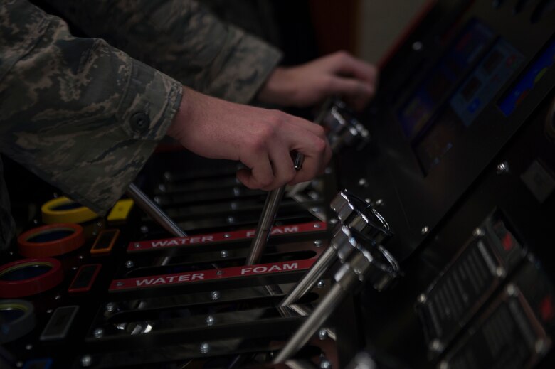 A firefighter assigned to the 97th Air Mobility Wing Fire Department uses a new pump operations simulator, Nov. 20, 2018, Altus Air Force Base, Okla. Simulators allow for more cost-efficient training, while still enabling a full variety of training to be accomplished in a more controlled environment. (U.S. Air Force photo by Airman First Class Jeremy Wentworth)