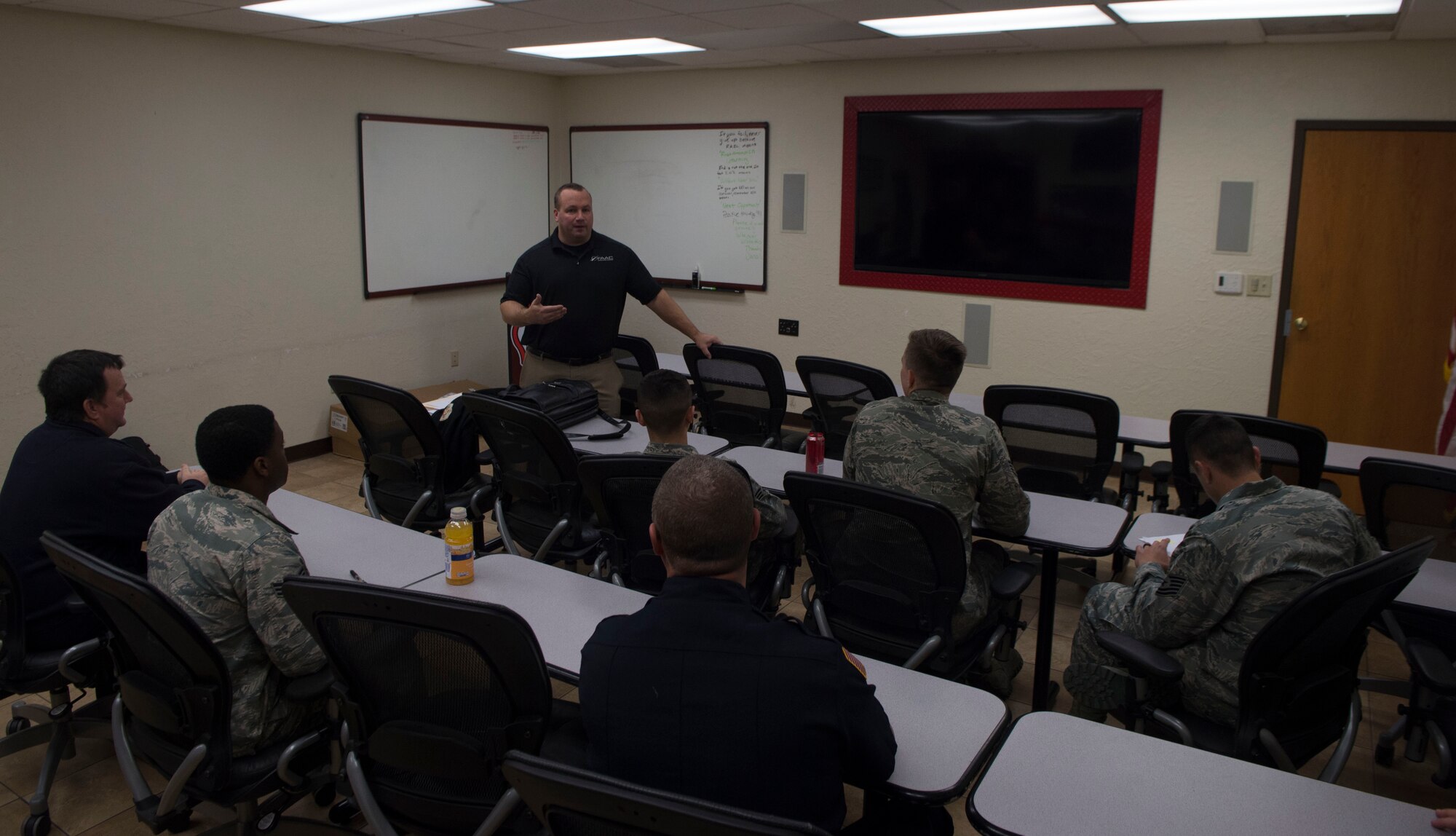 Phil Duczyminski, a subject matter specialist for FAAC, a firefighting simulation company, talks to the 97th Air Mobility Wing Fire Department about their new pump operations simulator, Nov. 20, 2018, Altus Air Force Base, Okla. The new simulator allows firefighters to test their skills and learn without the possibility of damaging equipment. (U.S. Air Force photo by Airman First Class Jeremy Wentworth)