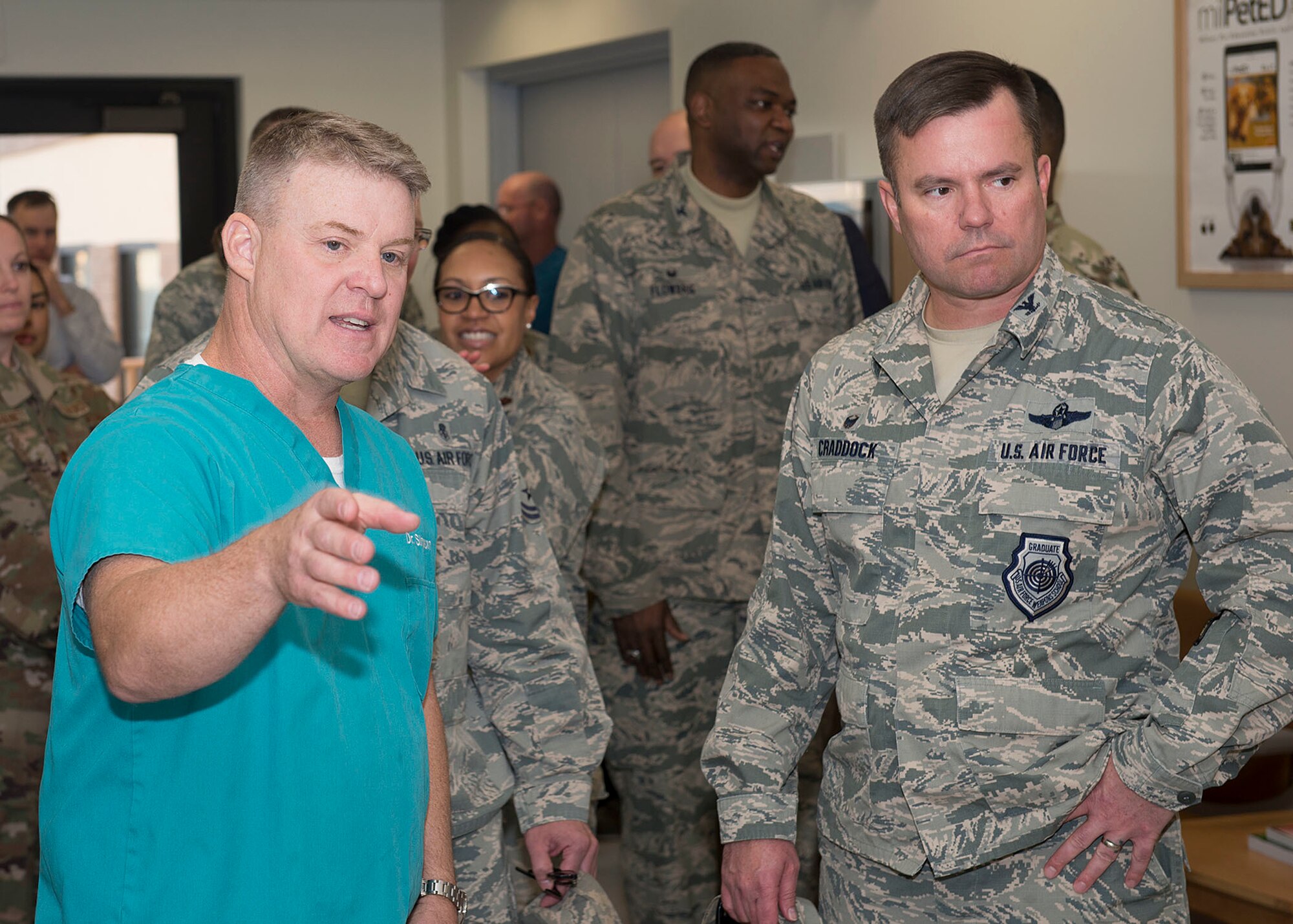 Base leadership, distinguished visitors and veterinary treatment facility staff cut the ribbon to signify the opening of the facility on Nellis Air Force Base, Nev., Nov. 14, 2018. The new facility is 3,600 square feet, which is twice the size of the previous facility. (U.S. Air Force photo by Airman 1st Class Bryan T. Guthrie)