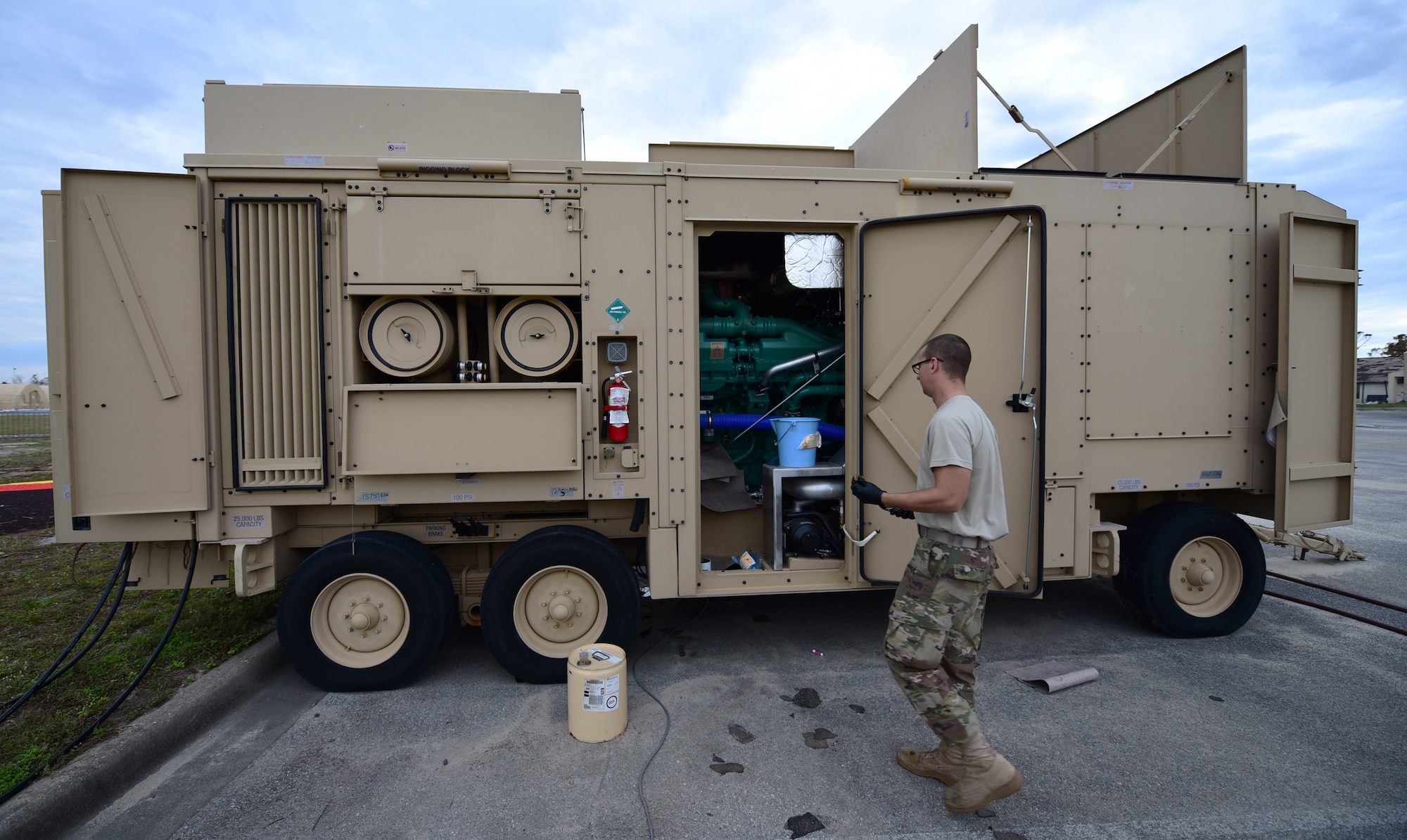 Staff Sgt. Joshua R. Olando, an electrical power production craftsman currently supporting the 325th Civil Engineer Squadron, prepares to change filters on a BPU 800 kilowatt high-voltage generator Nov. 30, 2018, at Tyndall Air Force Base, Fla. In the wake of Hurricane Michael, support and supplies from around the country poured in to assist Tyndall in recovery efforts. Olando is currently deployed from the 436th Civil Engineer Squadron at Dover Air Force Base, Del. (U.S. Air Force photo by Senior Airman Isaiah J. Soliz)
