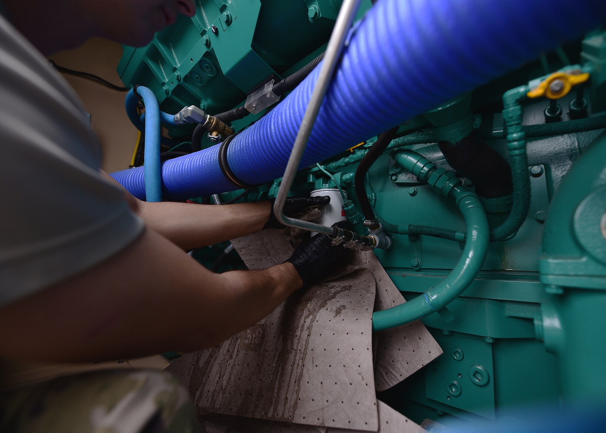 Staff Sgt. Joshua R. Olando, an electrical power production craftsman supporting the 325th Civil Engineer Squadron, installs new filters on a BPU 800 kilowatt high-voltage generator Nov. 30, 2018, at Tyndall Air Force Base, Fla. In the wake of Hurricane Michael, support and supplies from around the country poured in to assist Tyndall in recovery efforts. Olando is currently deployed from the 436th Civil Engineer Squadron at Dover Air Force Base, Del. (U.S. Air Force photo by Senior Airman Isaiah J. Soliz)