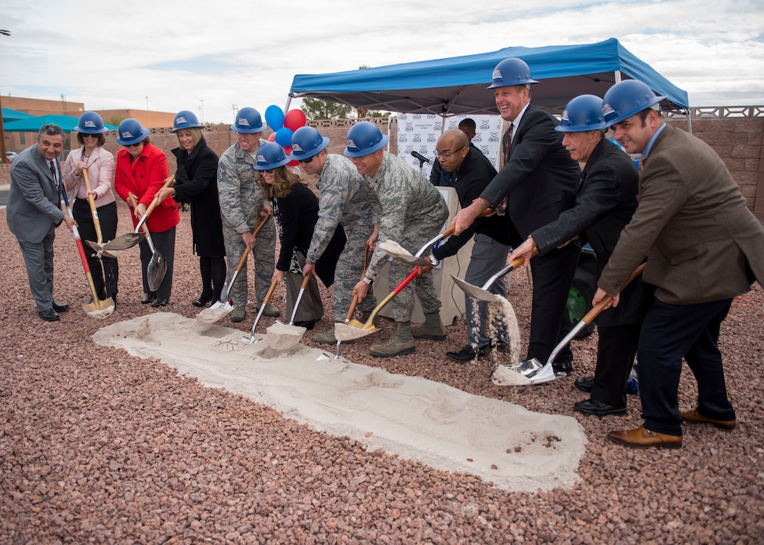 Leaders from Coral Academy of Science Las Vegas, Nellis Air Force Base, Nev. and the local community shovel sand during the Coral Academy groundbreaking ceremony on Nellis AFB, Nev., Nov. 28, 2018. The new school will replace the current Nellis AFB facility that was constructed in 1952. (U.S. Air Force photo by Airman 1st Class Dylan T. Murakami)
