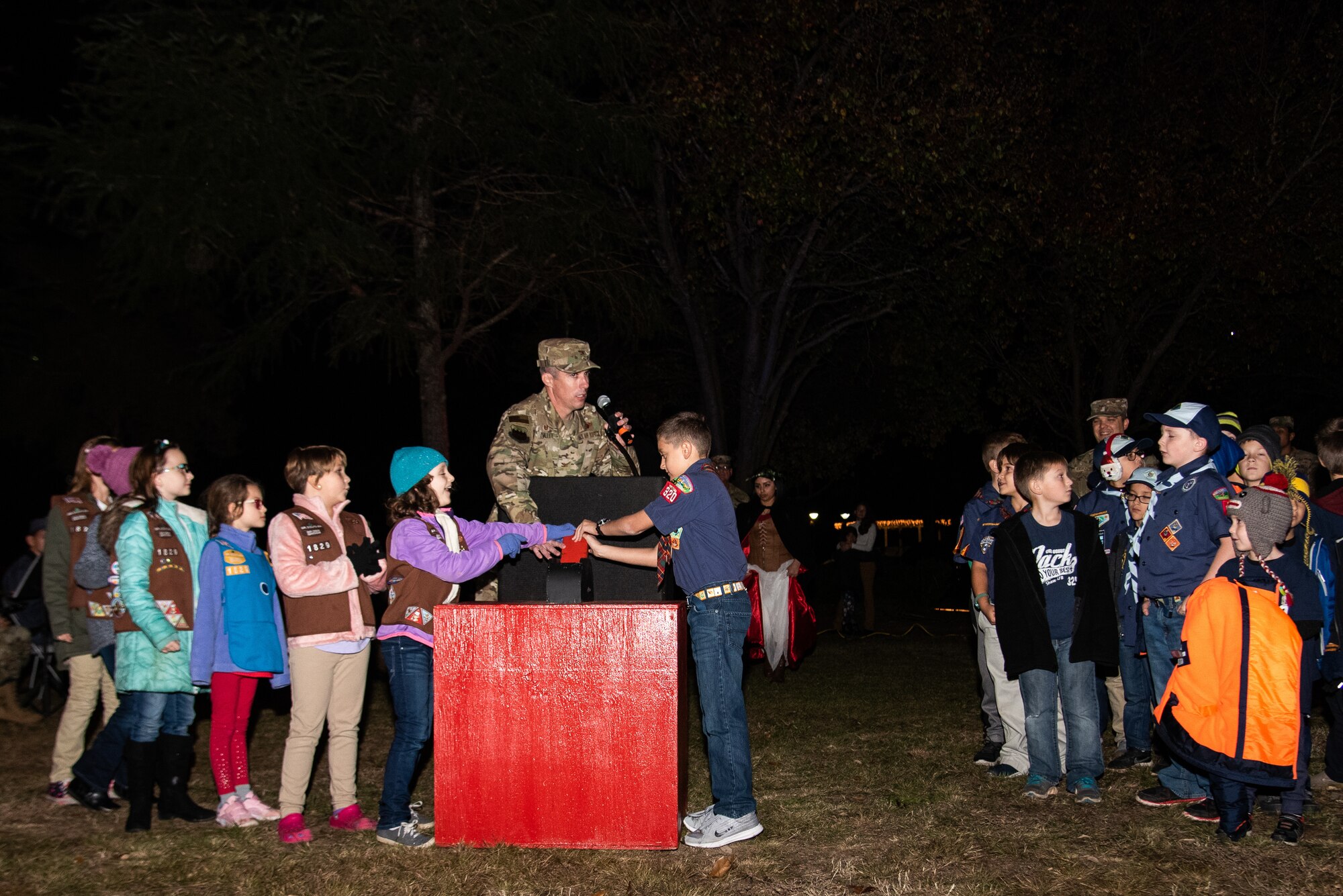 U.S. Air Force Derek O’Malley, 20th Fighter Wing (FW) commander, and local boy and girl scouts, flip the switch to turn on the lights at the annual Holiday Display Lighting Ceremony at Shaw Air Force Base S.C. Nov. 29, 2018.