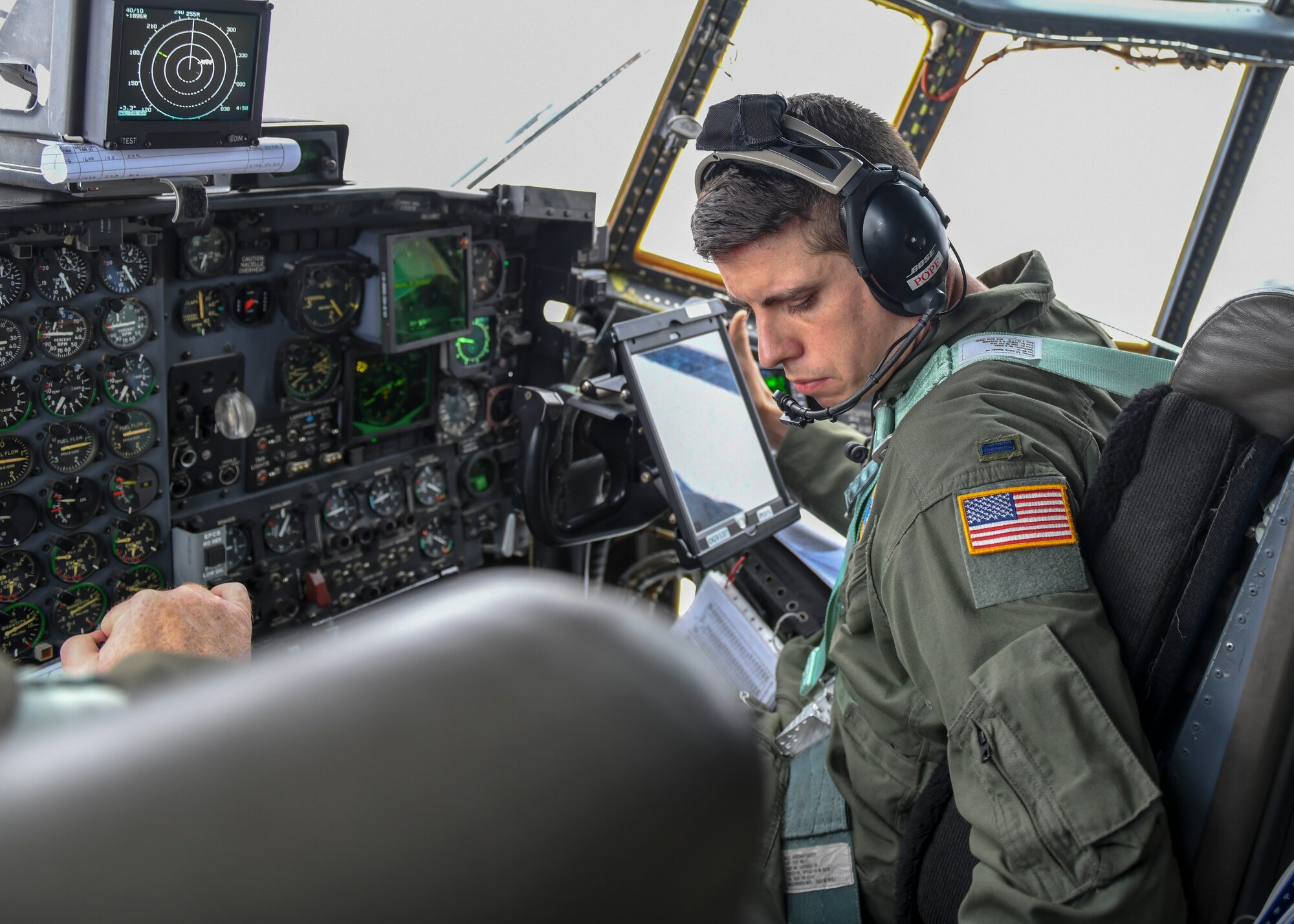 First Lt. John Pope, a pilot with the 757th Airlift Squadron sits in the co-pilot seat during a C-130H Hercules aircraft orientation flight for Junior Reserve Officer Training Corps cadets from Pine-Richland High School, Nov. 28, 2018.