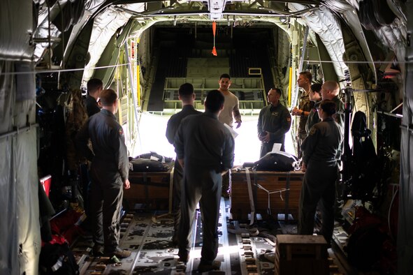 36th Airlift Squadron loadmasters discuss low-cost, low-altitude bundle rigging procedures in preparation for Operation Christmas Drop at Yokota Air Base, Japan Nov, 16, 2018. OCD is the longest running Department of Defense humanitarian airlift training operation and will provide nearly 25 tons of critical supplies to 56 Micronesian Islands this year impacting about 20,000 people. (U.S. Air Force photo by Tech. Sgt. Michael Smith)
