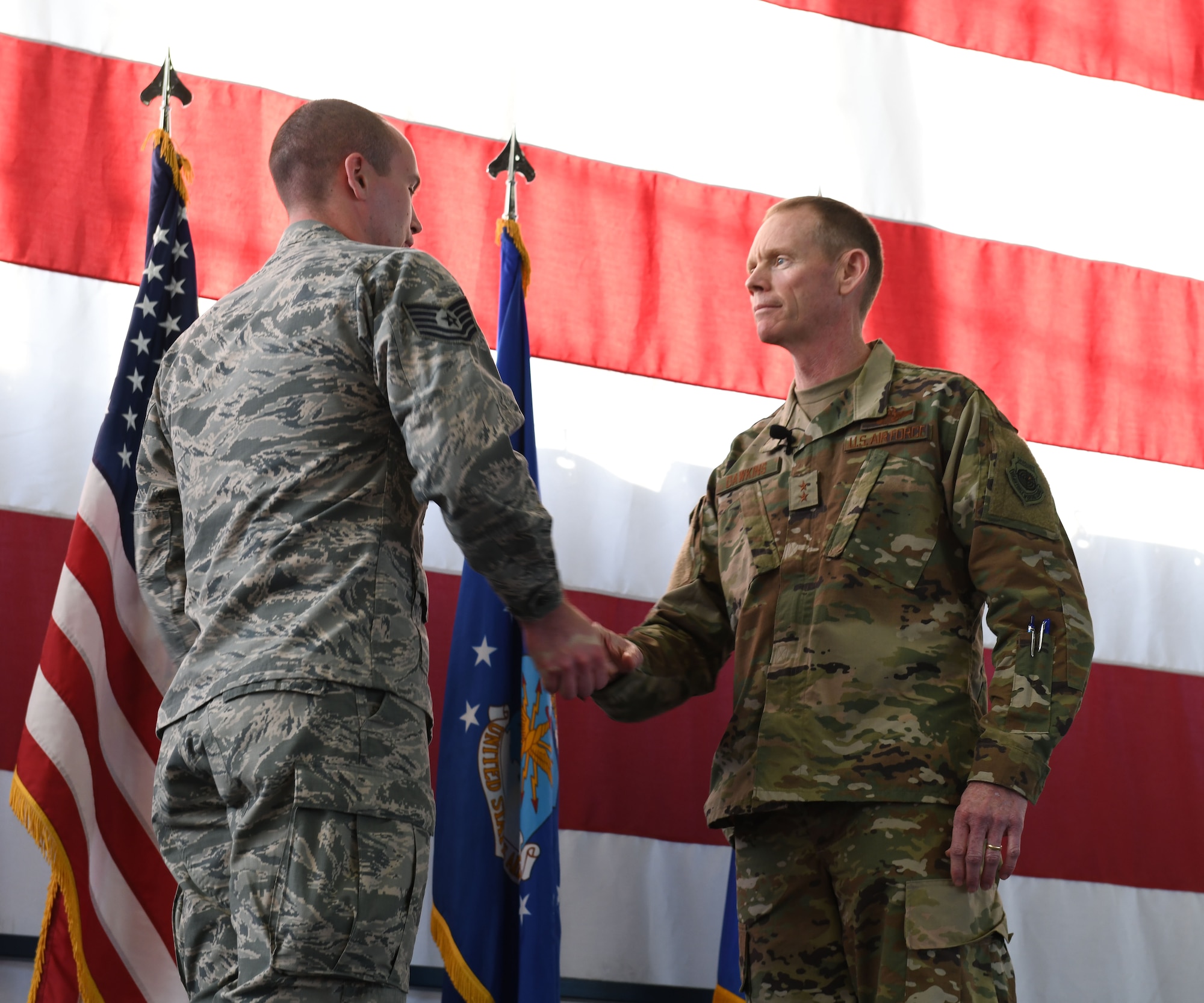 Maj. Gen. James Dawkins Jr., the 8th Air Force commander, coins Tech. Sgt. Robert Pilon, 28th Bomb Wing legal office, before his speech at Ellsworth Air Force Base, S.D., Nov. 13, 2018. Dawkins reminded Airmen to continuously strive for excellence. (U.S. Air Force photo by Airman 1st Class Thomas I. Karol)