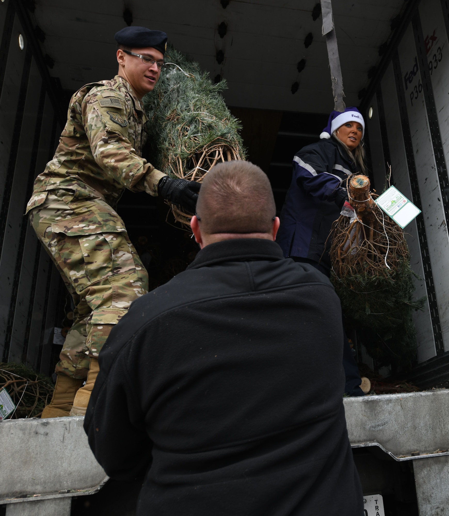 Volunteers help unload trees at Ellsworth Air Force Base, S.D., Nov. 30, 2018. Trees for Troops is an event where community members all over the country donate trees to service members so they can have a free tree for the holidays. (U.S. Air Force photo by Airman 1st Class Thomas Karol)