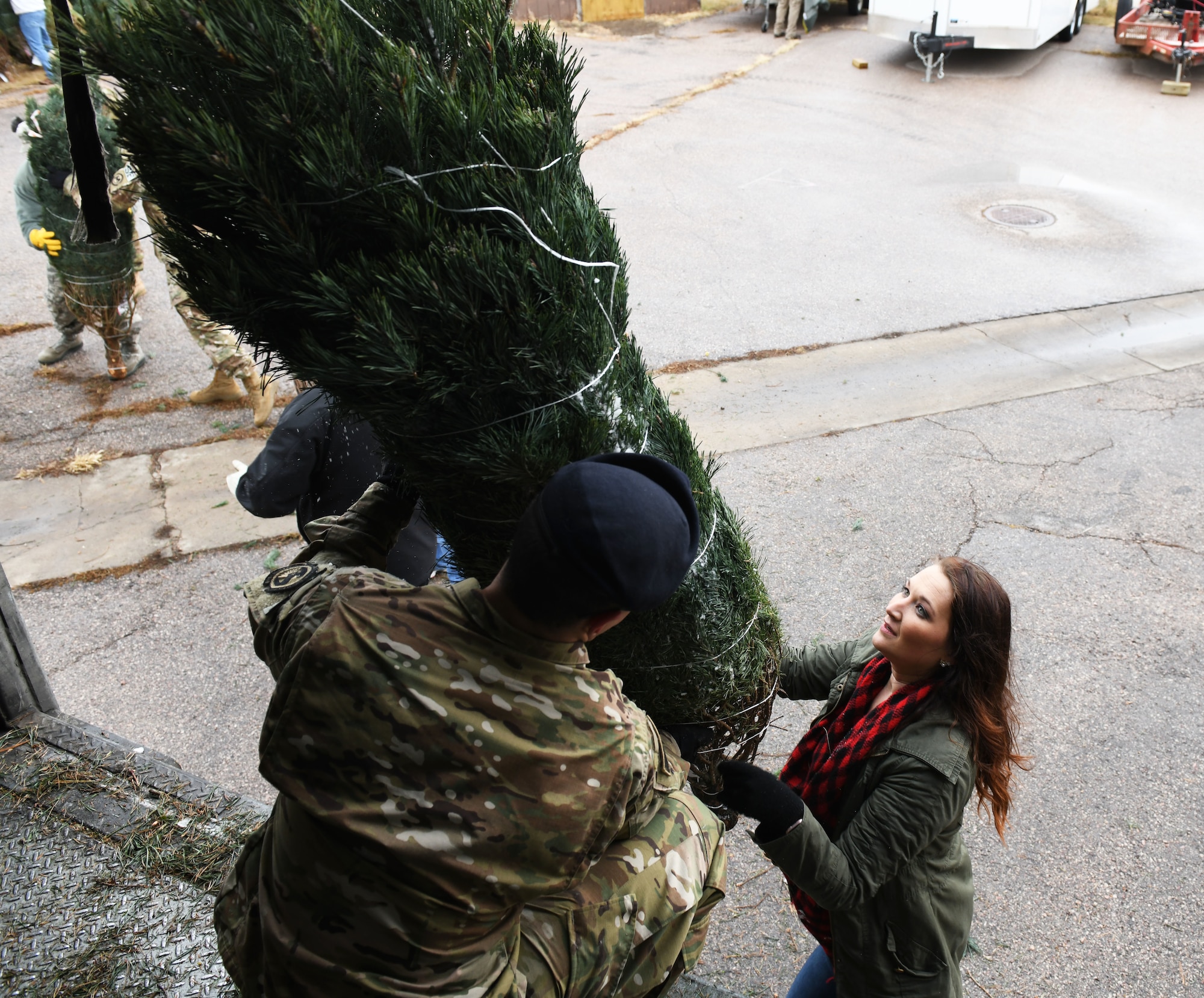 Chelsey Mastalski, the 28th Force Support Squadron outdoor recreation manager, unloads a tree from a truck at Ellsworth Air Force Base, S.D., Nov. 30, 2018. Trees for Troops is an event where community members all over the country donate trees to service members so they can have a free tree for the holidays. (U.S. Air Force photo by Airman 1st Class Thomas Karol)