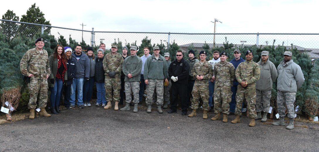 Volunteers come together to help unload trees at Ellsworth Air Force Base, S.D., Nov. 30, 2018. Trees for Troops is an event where community members all over the country donate trees to service members so they can have a free tree for the holidays. (U.S. Air Force photo by Airman 1st Class Thomas Karol)