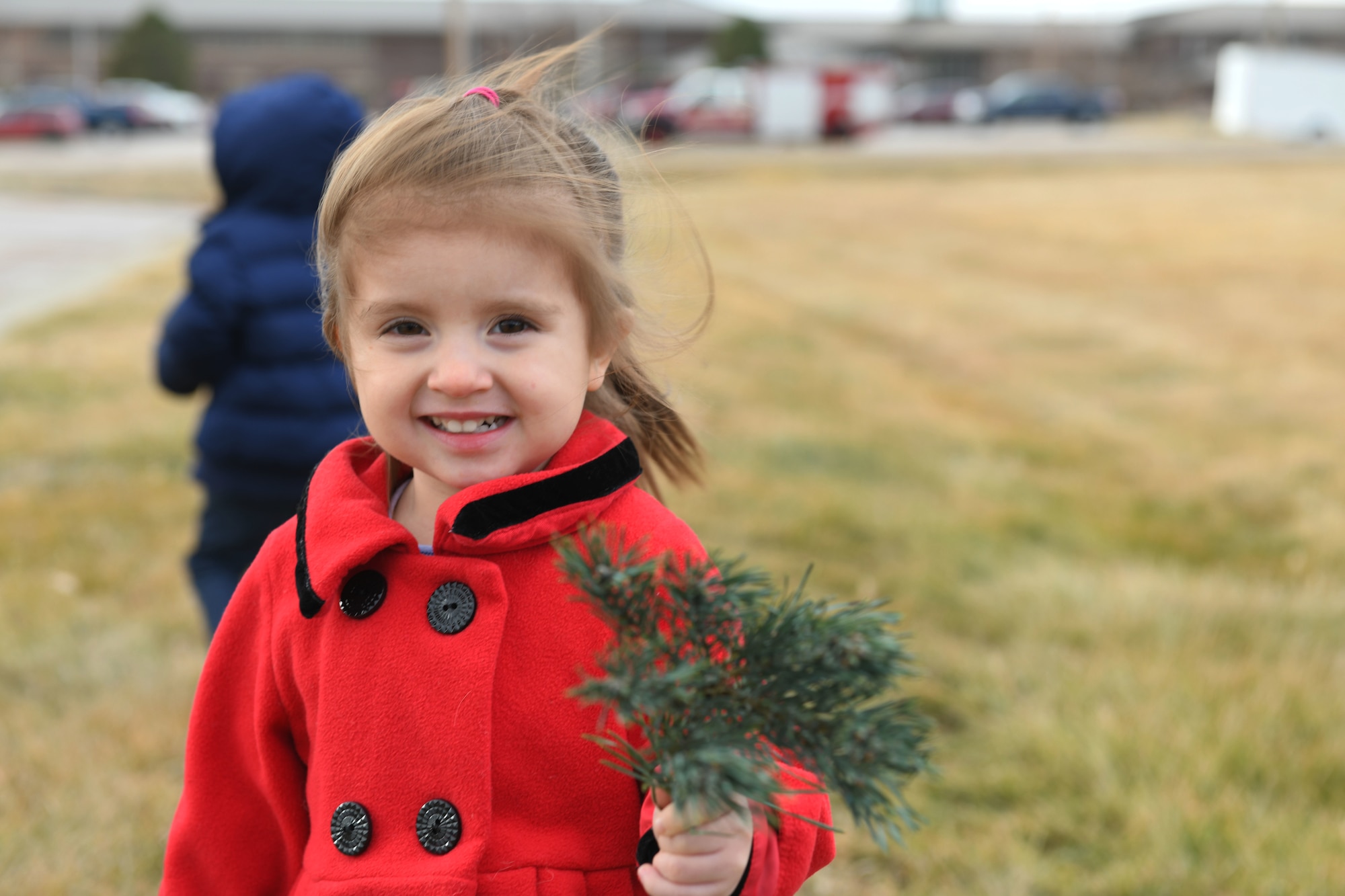 A child holds a branch while searching for tree at outdoor recreation on Ellsworth Air Force Base, S.D., Nov. 30, 2018. Trees for Troops is an event where community members all over the country donate trees to service members so they can have a free tree for the holidays. (U.S. Air Force photo by Airman 1st Class Thomas Karol)