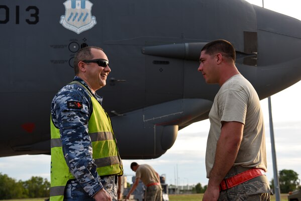 Royal Australian Air Force (RAAF) Leading Aircraftman Kevin Ewart, 13th Squadron aircraft refuler, and U.S. Air Force Staff. Sgt. Spencer Leger, 96th Expeditionary Aircraft Maintenance Unit crew chief, discuss refueling operations during exercise Lightning Focus at RAAF Base Darwin, Australia, Nov. 29, 2018.