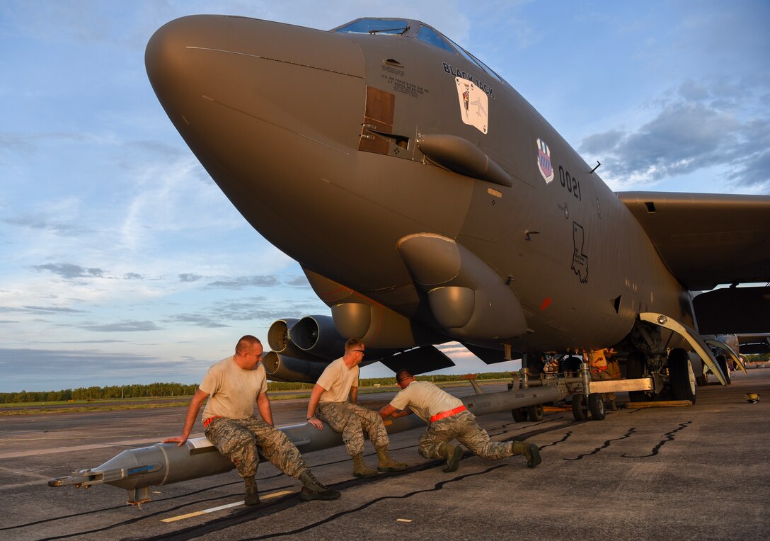 U.S. Air Force members from the 96th Expeditionary Aircraft Maintenance Unit shake a tow bar to maneuver it into place on a B-52 Stratofortress bomber during exercise Lightning Focus at Royal Australian Air Force (RAAF) Base Darwin, Australia, Nov. 29, 2018.