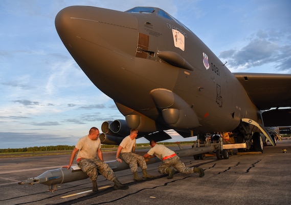 U.S. Air Force members from the 96th Expeditionary Aircraft Maintenance Unit shake a tow bar to maneuver it into place on a B-52 Stratofortress bomber during exercise Lightning Focus at Royal Australian Air Force (RAAF) Base Darwin, Australia, Nov. 29, 2018.