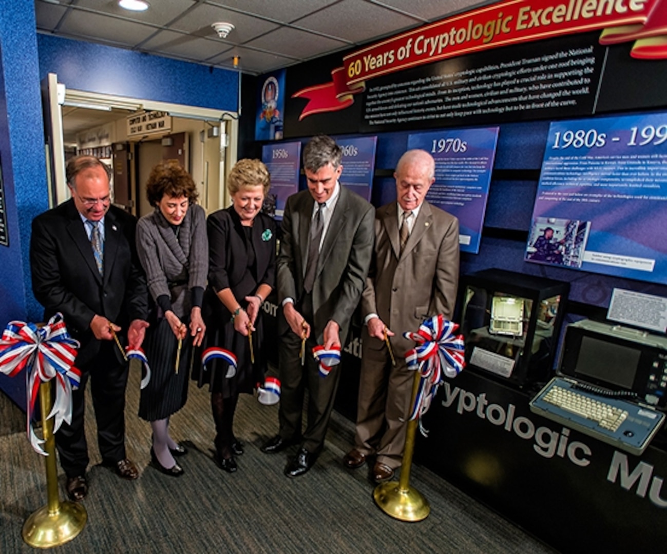 Photo of Senior executives from NSA and the National Cryptologic Museum Foundation cut the ribbon for the museum's newest exhibit.