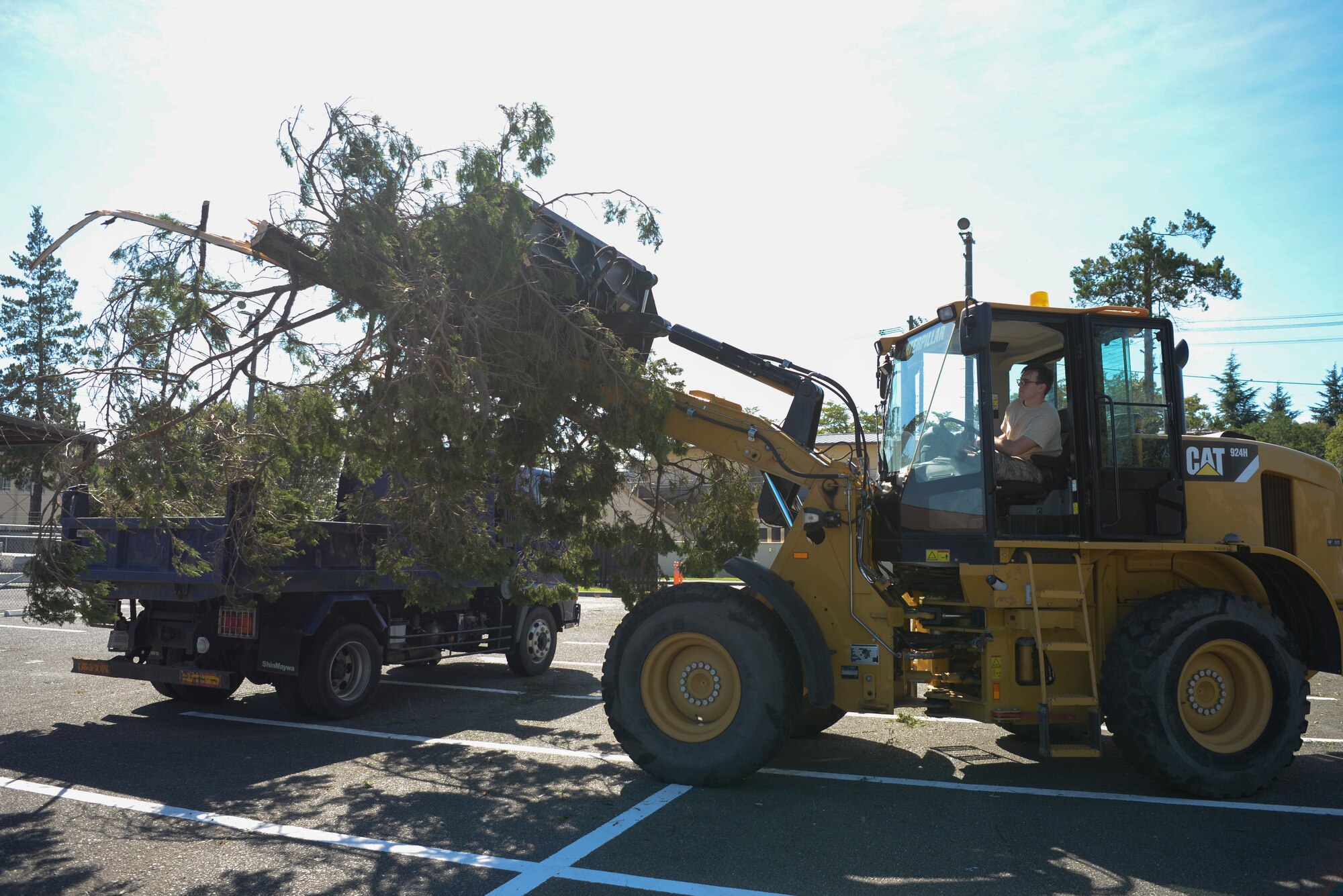 Airman 1st Class Benjamin McCranie, 374th Civil Engineer Squadron pavement and equipment technician, dumps debris into the back of a truck, Oct. 1, 2018, at Yokota Air Base, Japan.