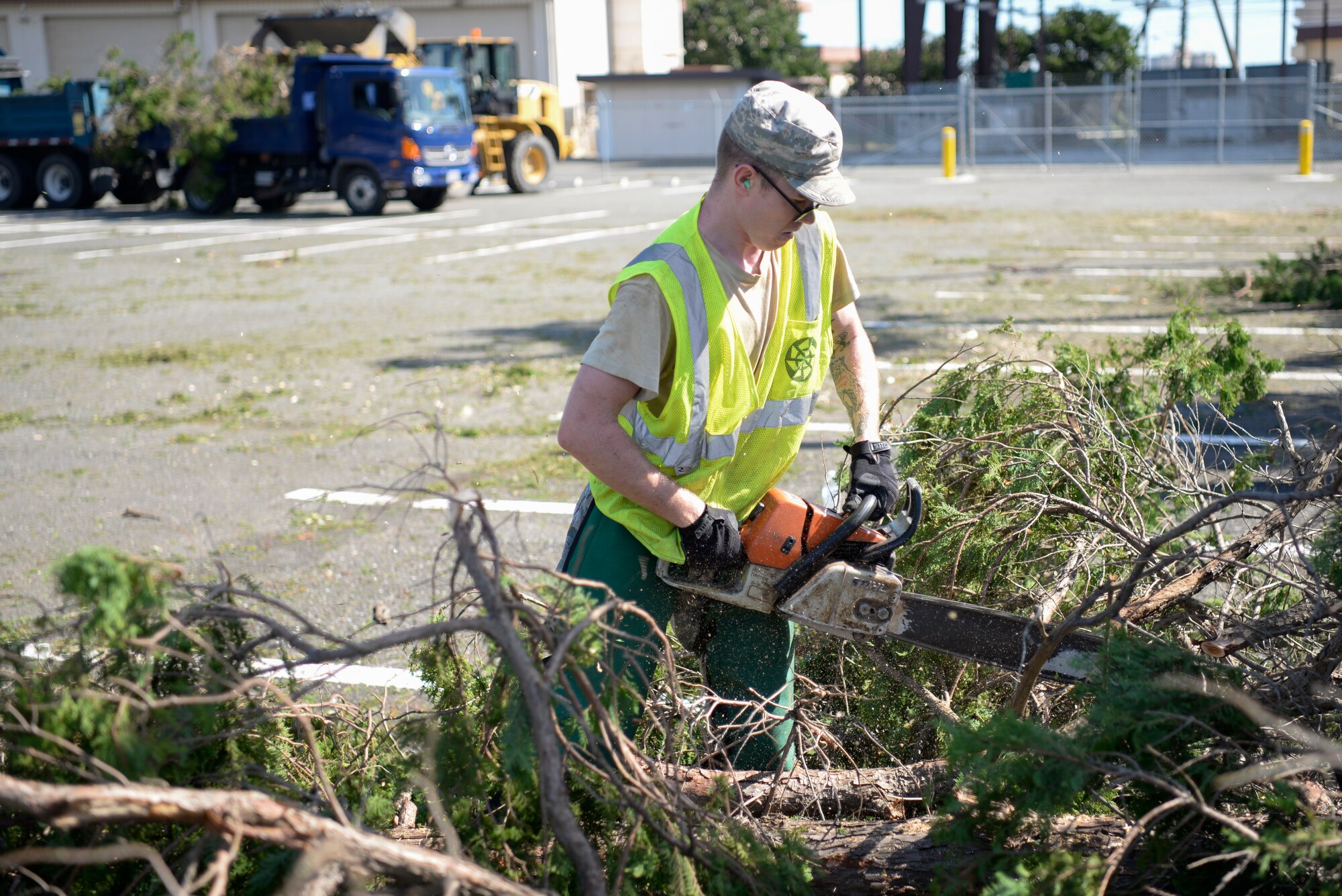 Airman Bradley Gustin, 374th Civil Engineer Squadron pavement and equipment technician, uses a chainsaw, Oct. 1, 2018, at Yokota Air Base, Japan.