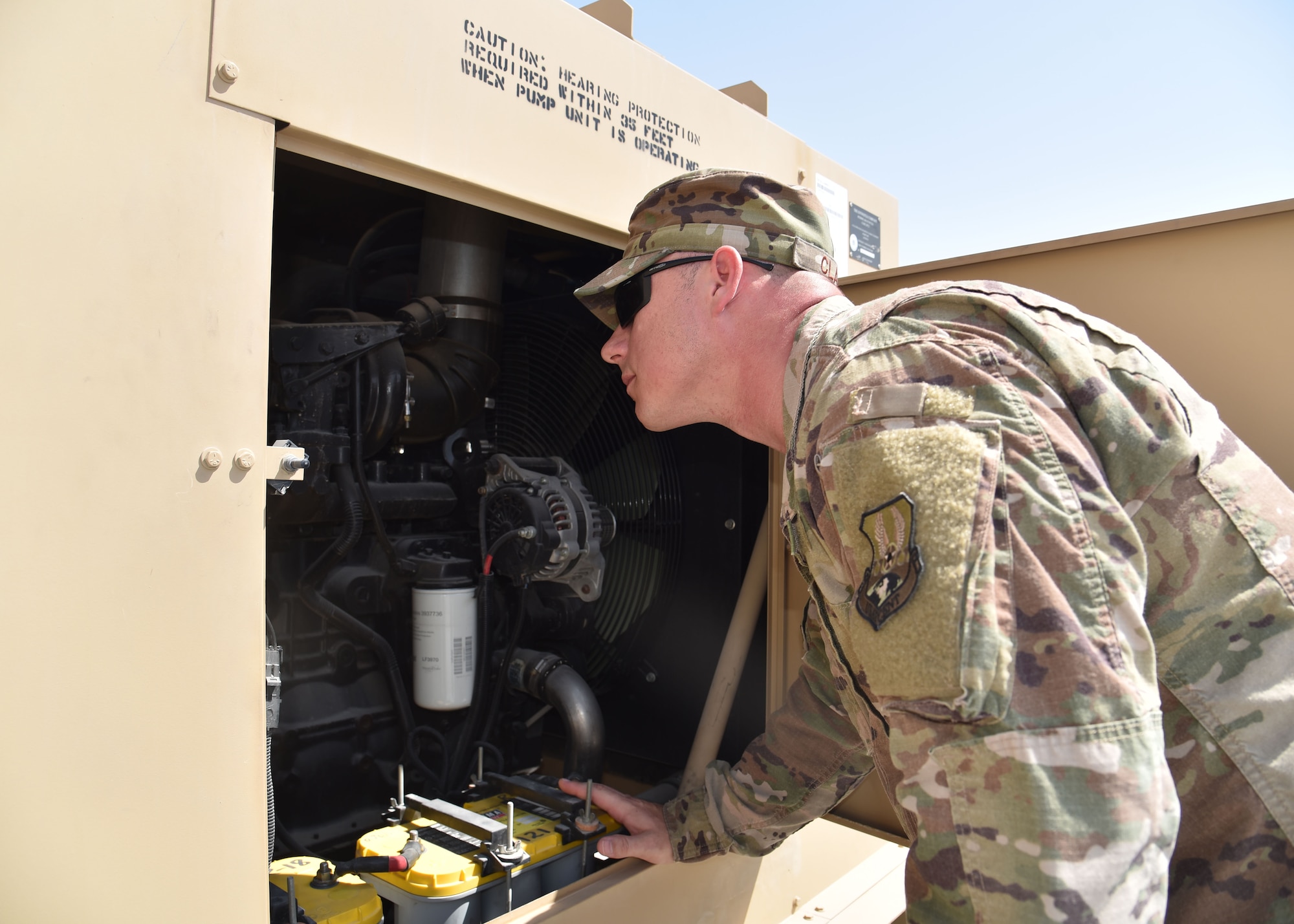 Tech. Sgt. Michael Clark, a fuel systems equipment contracting officer representative, Detachment 6, 379th Air Expeditionary Wing, inspects an R-18 pumping unit used to transfer fuel at Al Udeid Air Base, Qatar, Sept. 20, 2018. These units are used to provide fuel for Mine Resistant Ambush Protected armored vehicles as well as aircraft and other military modes of transportation. (U.S. Air Force photo by Staff Sgt. Enjoli Saunders)