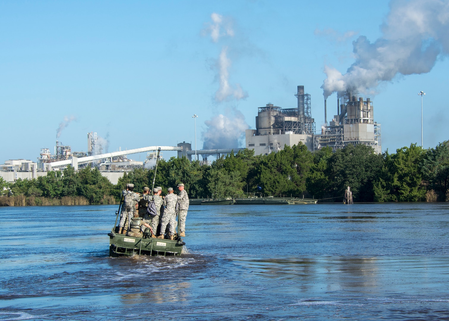 South Carolina National Guard Soldiers from the 125th Multi-Role Bridge Company, Abbeville, South Carolina, drive to a float bridge on the Sampit River in Georgetown, South Carolina, Sept. 26, 2018. The float bridge is used to transport main supplies to and from areas that can no longer be accessed by roadways.