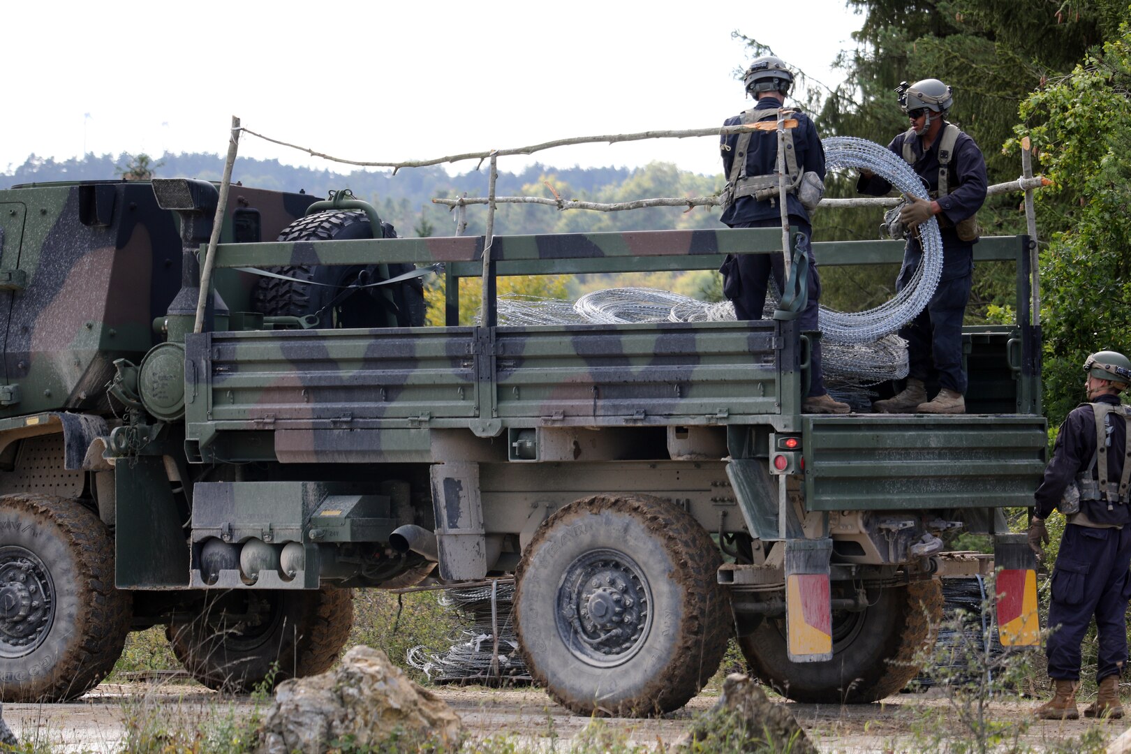 Soldiers from the 119th Sapper Company, West Virginia National Guard, unload concertina wire in preparation for placement in a Hohenfels training area.