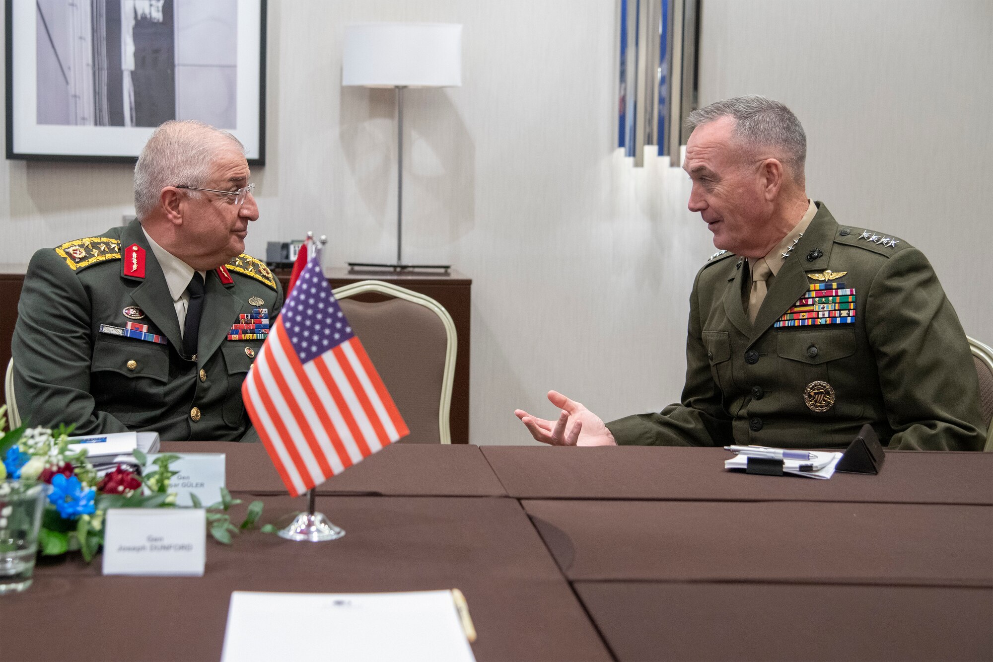 Marine Corps Gen. Joe Dunford, chairman of the Joint Chiefs of Staff, speaks with Turkish Gen.  Yaşar Güler, General Staff of the Republic of Turkey, during a bilateral meeting in between sessions of the NATO Military Committee Conference in Warsaw, Poland Sept. 29, 2018.