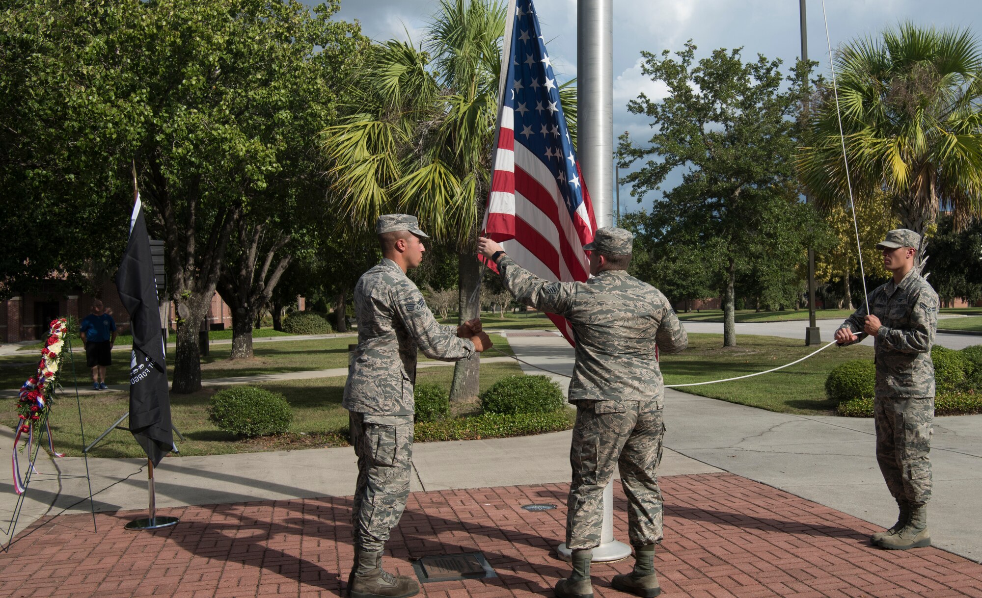 Members from Joint Base Charleston, S.C., lower the American flag during a retreat ceremony Sept. 28, 2018.