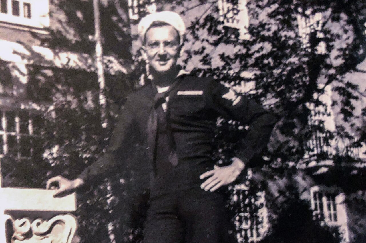 A young sailor poses for a photo.