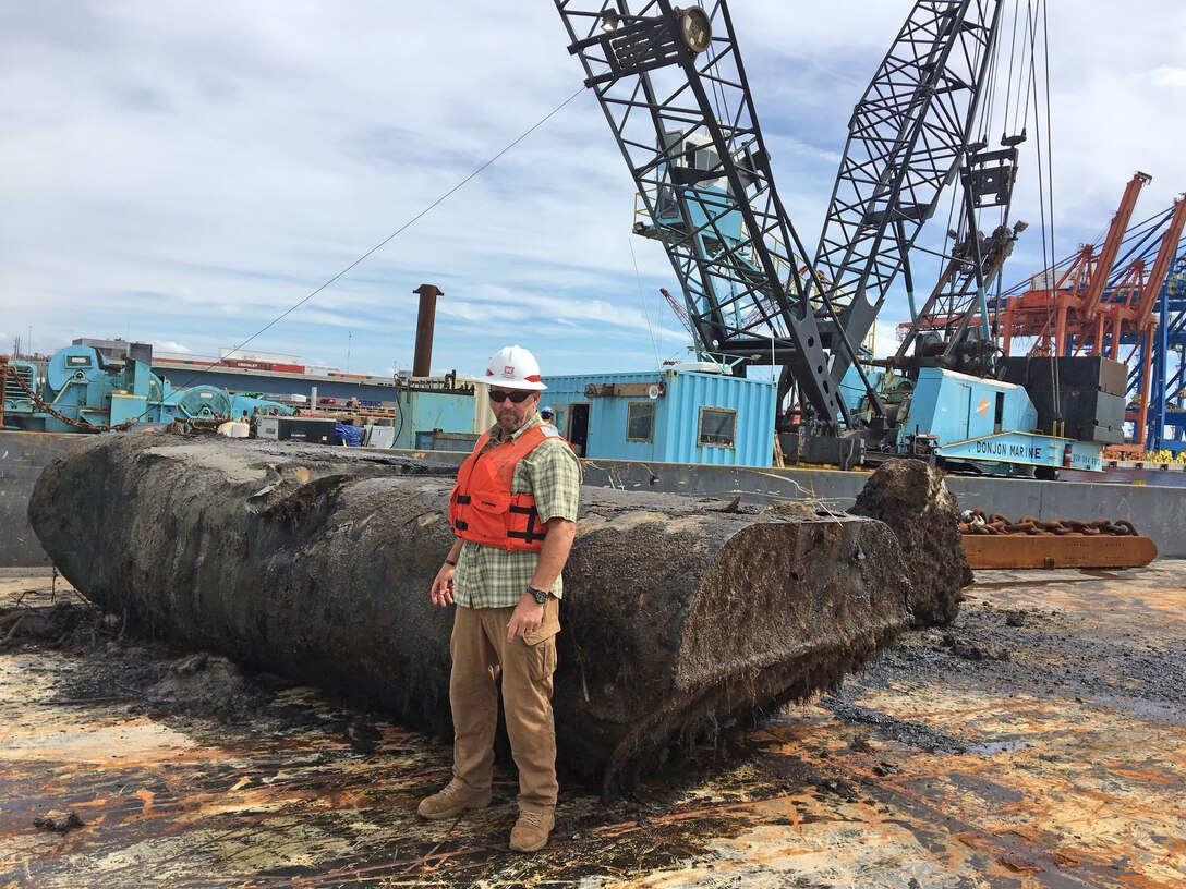 Wilmington District Chief of Navigation Roger Bullock stands before a pipeline dredge pontoon that was removed from the bottom of the Cape Fear River on Sept. 29 by salvage contractor Donjon Marine. Contractors also removed two large boulders and a boat from the Wilmington Harbor. The U.S. Coast Guard reports the federal channel in the Cape Fear River is free of obstructions.