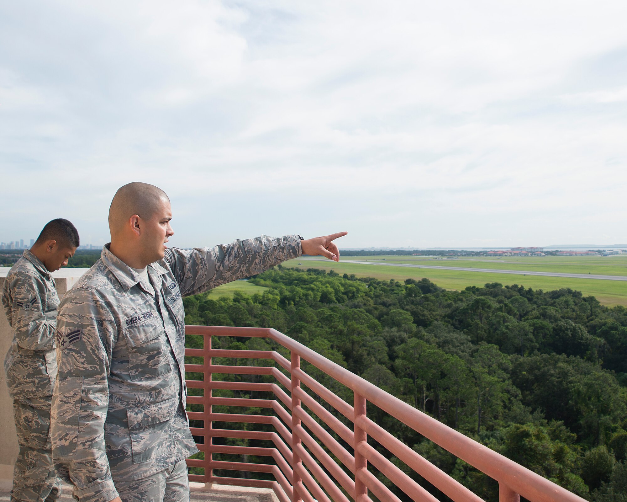 U.S. Air Force Senior Airman Daryl Rivera-Rivera, air traffic control journeyman assigned to the 6th Operation Support Squadron, and Airman 1st Class Julian Hurrey, air traffic control apprentice assigned to the 6th OSS, examine the flightline at MacDill Air Force Base, Florida, Oct. 1, 2018.