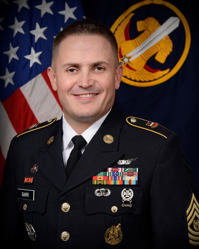 Official Command Photo of CSM Ryan Barr in Army Service Uniform with the United States flag and the Army Reserve Careers Division flag as a background, taken at Fort Knox, Kentucky VIOS facility.