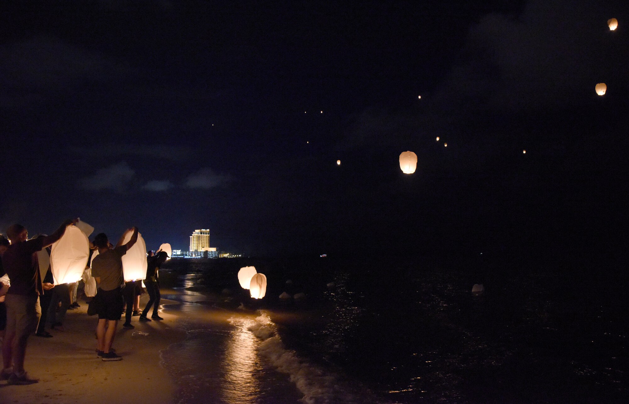 Keesler personnel and Biloxi citizens release sky lanterns during a sky lantern vigil on Biloxi Beach, Mississippi, Sept. 27, 2018. In recognition of suicide prevention and awareness month, the 81st Medical Operations Squadron mental health team hosted the themed event, Lights For Life, to honor the memories of victims of suicide. (U.S. Air Force photo by Kemberly Groue)