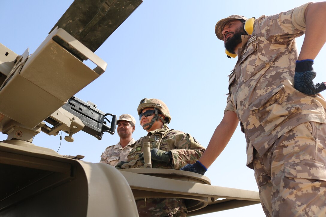 Spc. Eric Garcia, Alpha Company, 578th Brigade Engineer Battalion, awaits for commands from the range NCOIC while Qatari range safeties look on at Al-Ghalail range, Sep. 12, 2018. The range provided a unique opportunity for Soldiers to build rapport with the Qatari soldiers from a Qatari base near Camp As Sayliyah.