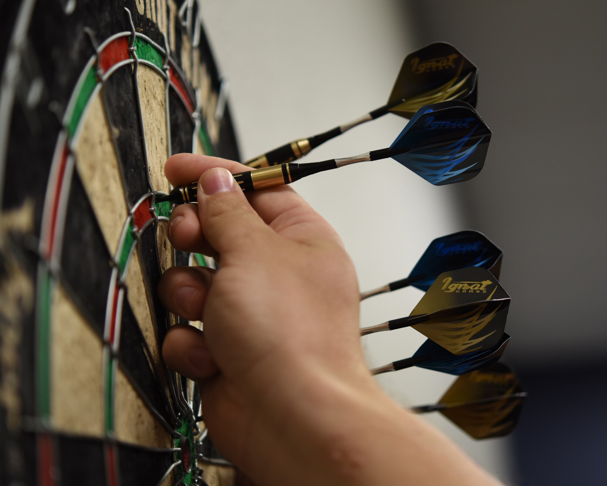 An Airmen assigned to the 56th Fighter Wing collects his darts during the third annual Thunderbolt Cup Sept. 28, 2018, at Luke Air Force Base, Ariz.