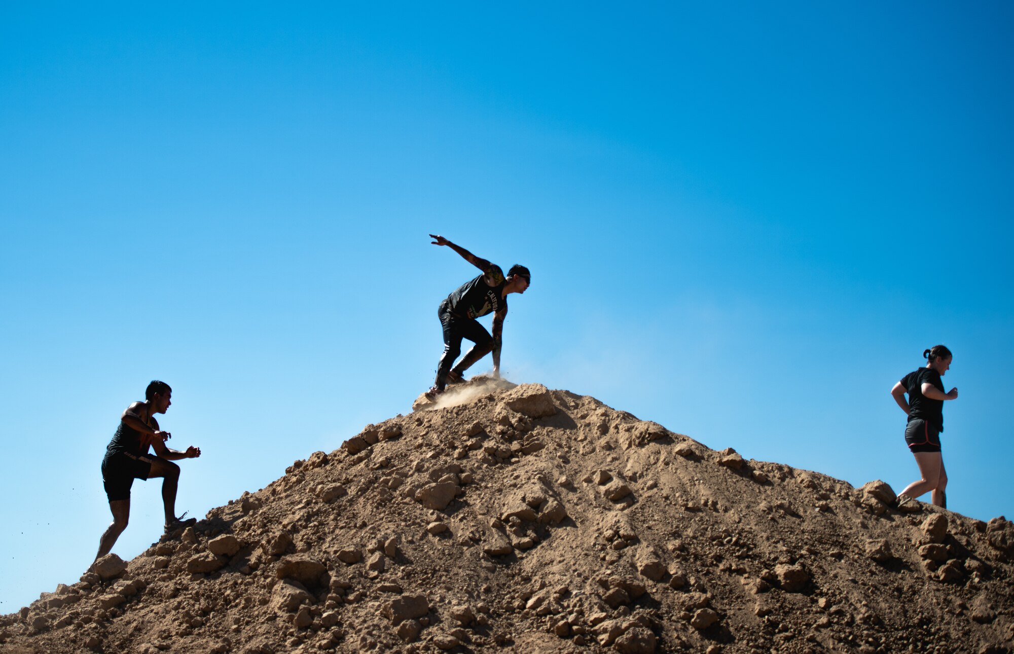 Thunderbolt Cup participants climb up an obstacle during a mud run event as part of the third annual Thunderbolt Cup Sept. 27, 2018, at Luke Air Force Base, Ariz.