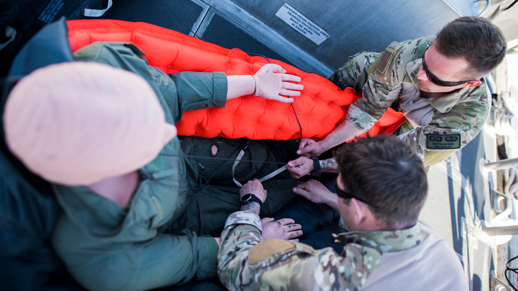 Two 27th Special Operations Support Squadron Survival, Evasion, Resistance and Escape specialists, attach a training dummy to a life raft during a full mission profile exercise at Channel Islands Harbor in Oxnard, Calif., Sept. 18, 2018. Airmen boarded a U.S. Coast Guard boat and tested search and rescue operations with cooperating aircraft. An FMP provides participants the opportunity to refine their tactics, techniques and procedures in operating in a maritime environment. (U.S. Air Force photo by Staff Sgt. Michael Washburn)