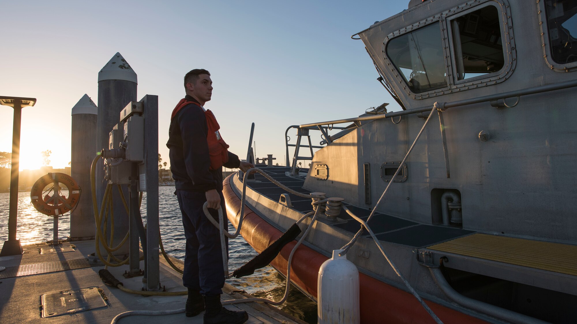 A U.S. Coast Guardsman prepares to launch a boat from the Channel Islands Harbor in Oxnard, Calif., in support of a full mission profile Sept. 18, 2018. Airmen boarded a U.S. Coast Guard boat and tested search and rescue operations with cooperating aircraft. An FMP provides participants the opportunity to refine their tactics, techniques and procedures in operating in a maritime environment. (U.S. Air Force photo by Staff Sgt. Michael Washburn)