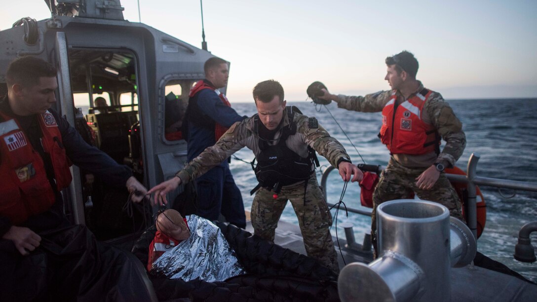 U.S. Air Force Staff Sgt. Taylor Fisher, 27th Special Operations Support Squadron Survival, Evasion, Resistance and Escape specialist, prepares a training dummy to be thrown overboard during a full mission profile exercise off the coast of Oxnard, Calif., Sept. 18, 2018. Airmen boarded a U.S. Coast Guard boat and tested search and rescue operations with cooperating aircraft. An FMP provides participants the opportunity to refine their tactics, techniques and procedures in operating in a maritime environment. (U.S. Air Force photo by Staff Sgt. Michael Washburn)