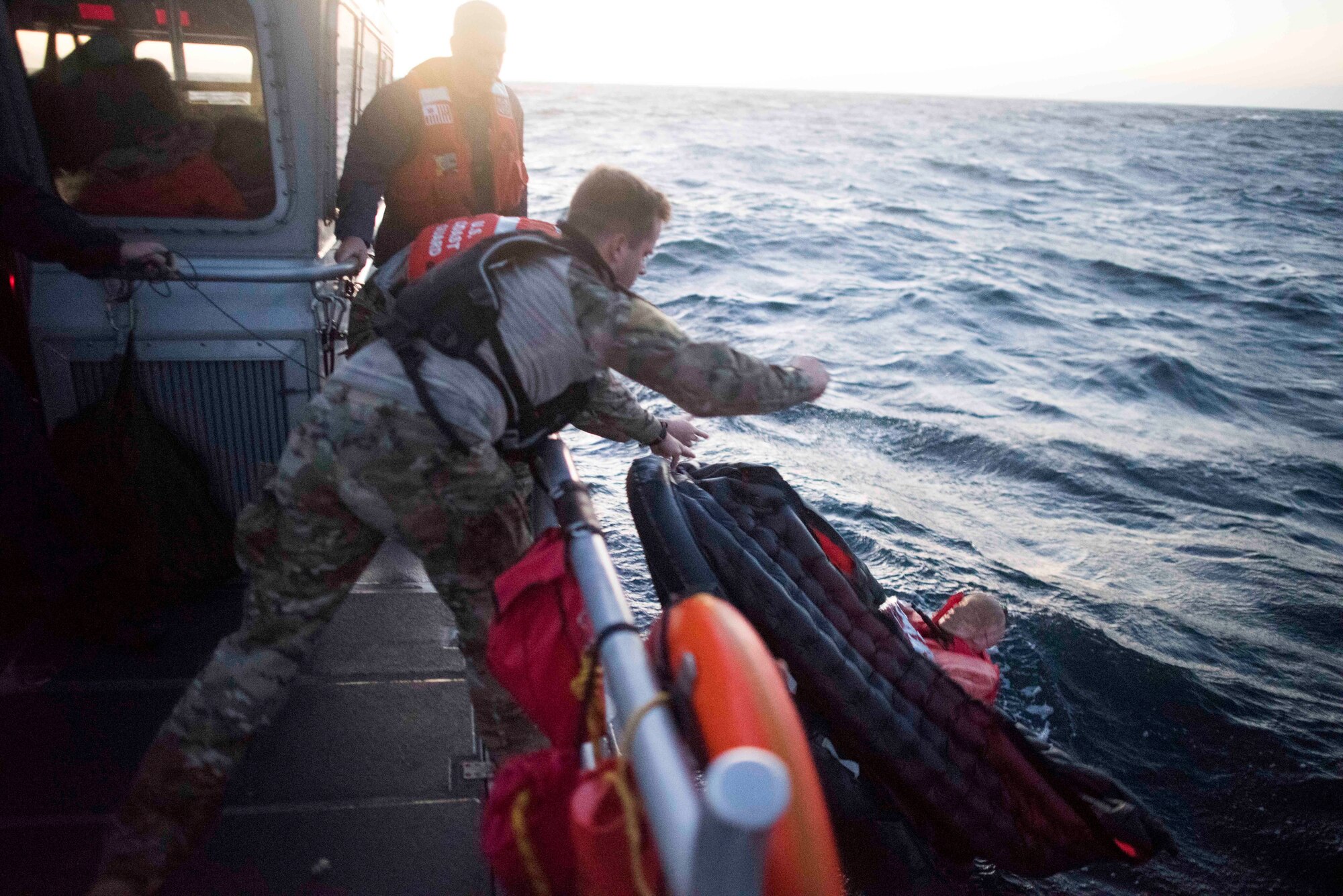 U.S. Air Force Staff Sgt. Taylor Fisher, 27th Special Operations Support Squadron Survival, Evasion, Resistance and Escape specialist, tosses a training dummy overboard during a full mission profile off the coast of Oxnard, Calif., Sept. 18, 2018. Airmen boarded a U.S. Coast Guard boat and tested search and rescue operations with cooperating aircraft. An FMP provides participants the opportunity to refine their tactics, techniques and procedures in operating in a maritime environment. (U.S. Air Force photo by Staff Sgt. Michael Washburn)