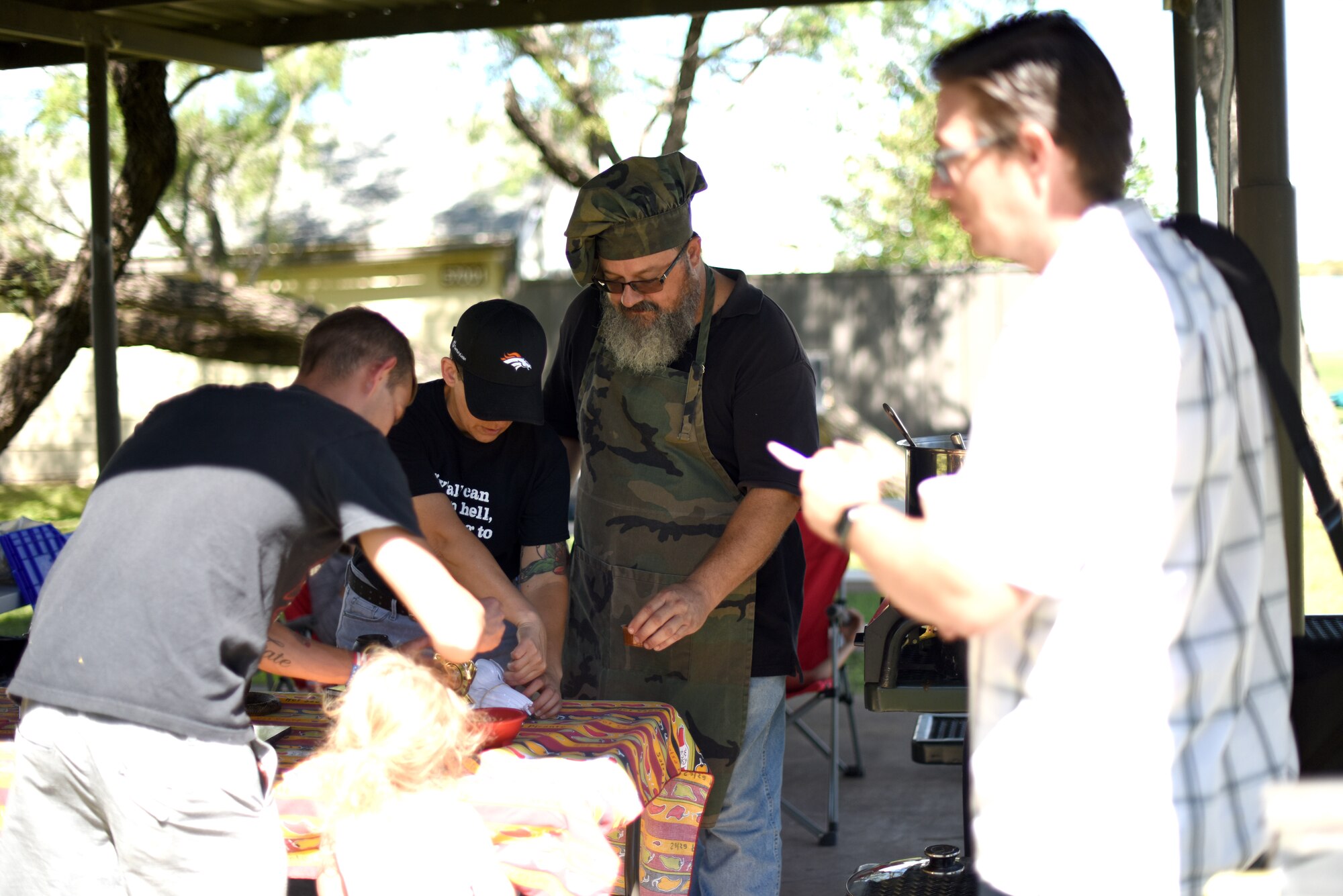 A 312th Training Squadron Logistics Technician, Russell Dunlap, 44th Annual Armed Forces Terlingua Chili Cook-Off participant gives out samples to attendees during the Ruckus at the Rec Camp at Goodfellow Air Force Base Recreation Camp San Angelo, Texas, Sept. 29, 2018. Cooks turned in their chili to be judged and ranked. The top three competitors earn competition rights for the Terlingua International Chili Championship. (U.S. Air Force photo by Airman 1st Class Seraiah Hines/Released)
