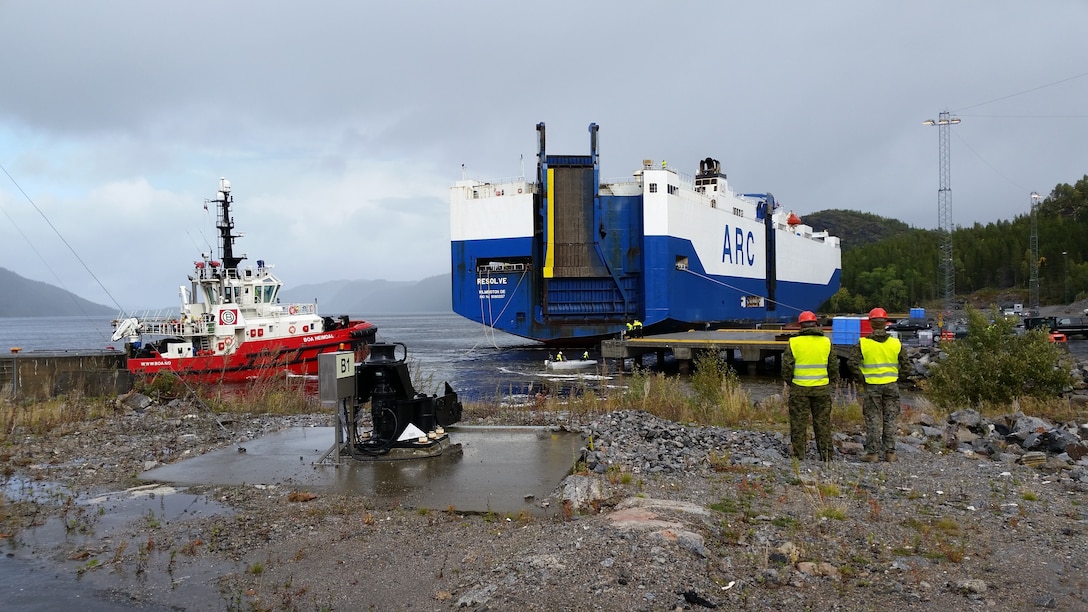 U.S. Marines with II Marine Expeditionary Force, standby to off-load equipment for NATO exercise Trident Juncture from the ARC Resolve in Hammernesodden, Norway, Sept. 23, 2018. Marines and service members from the Norwegian Armed Services unloaded nearly 200 military vehicles and more than 70 containers with military equipment as planned in two days despite cold weather with periods of rain and sleet. Seven different organizations, which had never worked together before came together on a shortened timeline and conducted a successful operation, said Maj. Valerie Schwindt, operations officer, Arrival and Assembly Operation Group, II MEF. Trident Juncture is the largest live NATO exercise since 2002 and is scheduled to take place in October with more than 40,000 troops from 28 allied nations participating.
