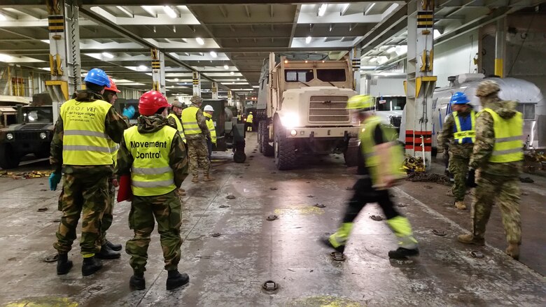 U.S. Marines with II Marine Expeditionary Force, maneuver vehicles to off-load them for NATO exercise Trident Juncture from ARC Resolve in Hammernesodden, Norway, Sept. 23, 2018. Marines and service members from the Norwegian Armed Services unloaded nearly 200 military vehicles and more than 70 containers with military equipment as planned in two days despite cold weather with periods of rain and sleet. Seven different organizations, which had never worked together before came together on a shortened timeline and conducted a successful operation, said Maj. Valerie Schwindt, operations officer, Arrival and Assembly Operation Group, II MEF. Trident Juncture is the largest live NATO exercise since 2002 and is scheduled to take place in October with more than 40,000 troops from 28 allied nations participating.