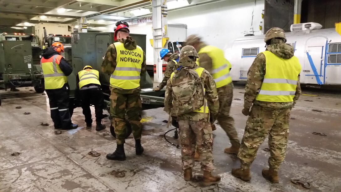 U.S. Marines with II Marine Expeditionary Force, Norwegian service members and federal employees of Norway pose after off-loading military vehicles and equipment in preparation for NATO exercise Trident Juncture from ARC Resolve in Hammernesodden, Norway, Sept. 24, 2018. Marines and service members from the Norwegian Armed Services unloaded nearly 200 military vehicles and more than 70 containers with military equipment as planned in two days despite cold weather with periods of rain and sleet. Seven different organizations, which had never worked together before came together on a shortened timeline and conducted a successful operation, said Maj. Valerie Schwindt, operations officer, Arrival and Assembly Operation Group, II MEF. Trident Juncture is the largest live NATO exercise since 2002 and is scheduled to take place in October with more than 40,000 troops from 28 allied nations participating.