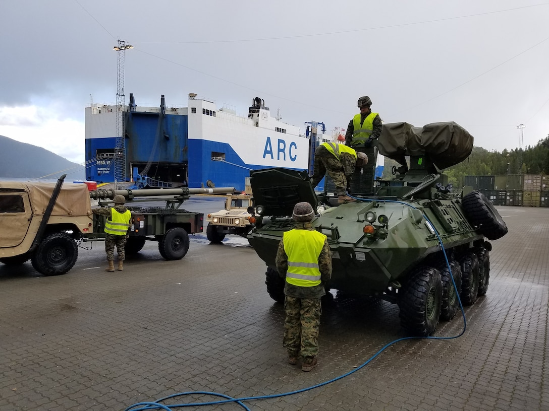 U.S. Marines with II Marine Expeditionary Force, maneuver vehicles while off-loading equipment for NATO exercise Trident Juncture from ARC Resolve in Hammernesodden, Norway, Sept. 24, 2018. Marines and service members from the Norwegian Armed Services unloaded nearly 200 military vehicles and more than 70 containers with military equipment as planned in two days despite cold weather with periods of rain and sleet. Seven different organizations, which had never worked together before came together on a shortened timeline and conducted a successful operation, said Maj. Valerie Schwindt, operations officer, Arrival and Assembly Operation Group, II MEF. Trident Juncture is the largest live NATO exercise since 2002 and is scheduled to take place in October with more than 40,000 troops from 28 allied nations participating.