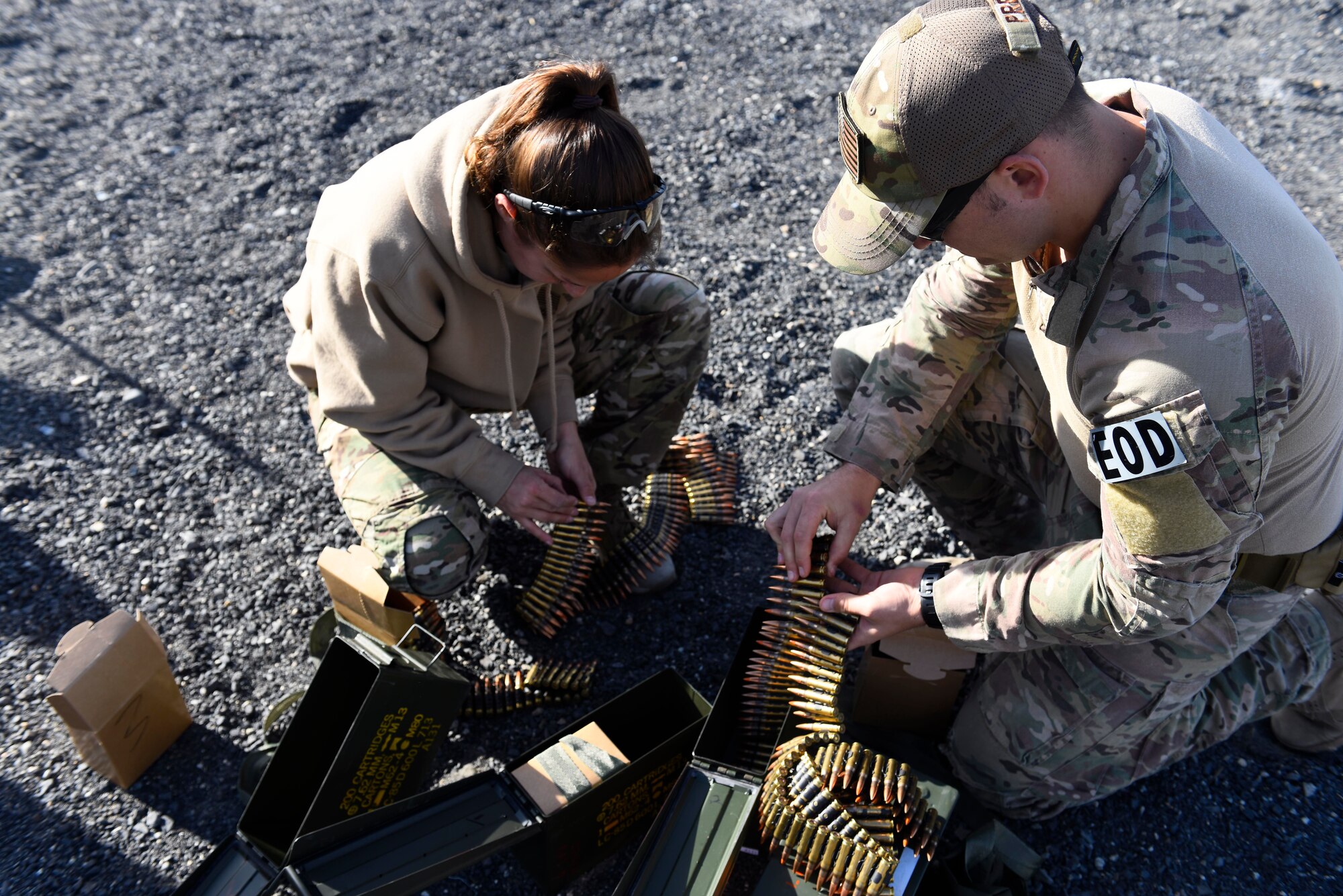 Senior Airman Erika Andresen and Senior Airman Taylor Preza, 92nd Civil Engineer Squadron explosive ordinance disposal technicians, prepare ammunition prior to weapons qualifications at Coulee Dam, Washington, Sept. 26, 2018. Since a deployment tasking can happen at an time, EOD technicians need to maintain annual weapons qualifications in order to stay mission ready. (U.S. Air Force photo/Airman 1st Class Lawrence Sena)