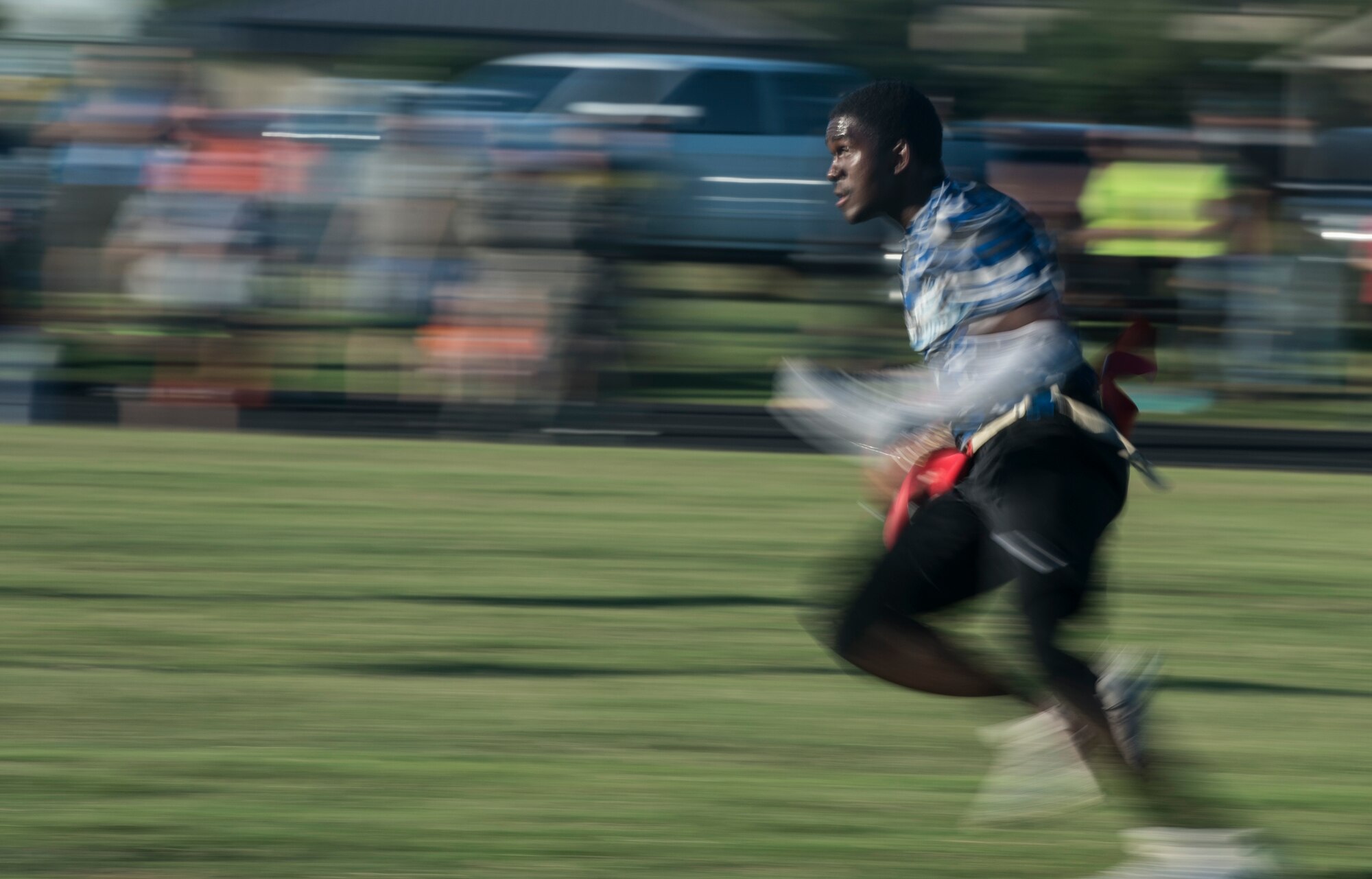 A player from the 97th Logistics Readiness Squadron football team runs after receiving the ball during the 97th Air Mobility Wing Flag Football Championships Sept. 28, 2018 on Altus Air Force Base, Okla. The 97th Operations Support Squadron and the LRS played two games against each other with OSS winning the first, and LRS winning the second game to become the champions. (U.S. Air Force photo by A1C Jeremy Wentworth)