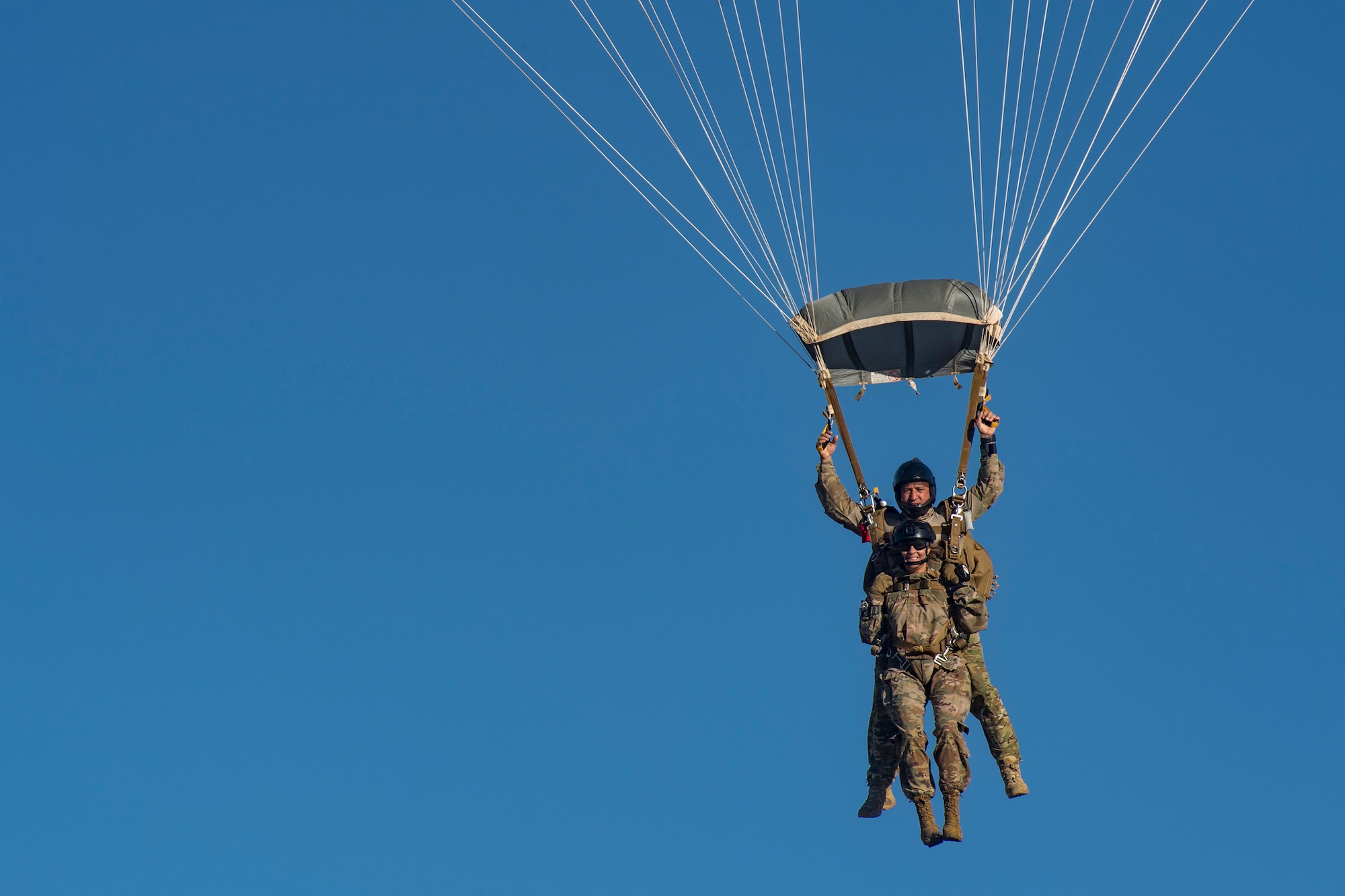 Col. Jennifer Short, front, 23d Wing commander, and Kirby Rodriguez, 563d Rescue Group instructor, prepare to land following a tandem jump, Sept. 27, 2018, over Davis-Monthan Air Force Base, Nev. Effective 1 Oct., the 563d RQG and its associated maintenance squadrons will be realigned from the 23d WG to the 355th Fighter Wing. (U.S. Air Force photo by Staff Sgt. Ryan Callaghan)